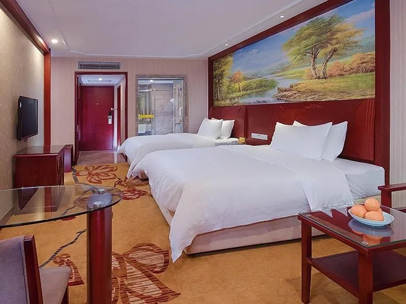 Bed in Vienna International Hotel Guangzhou Jiaokou Subway Station