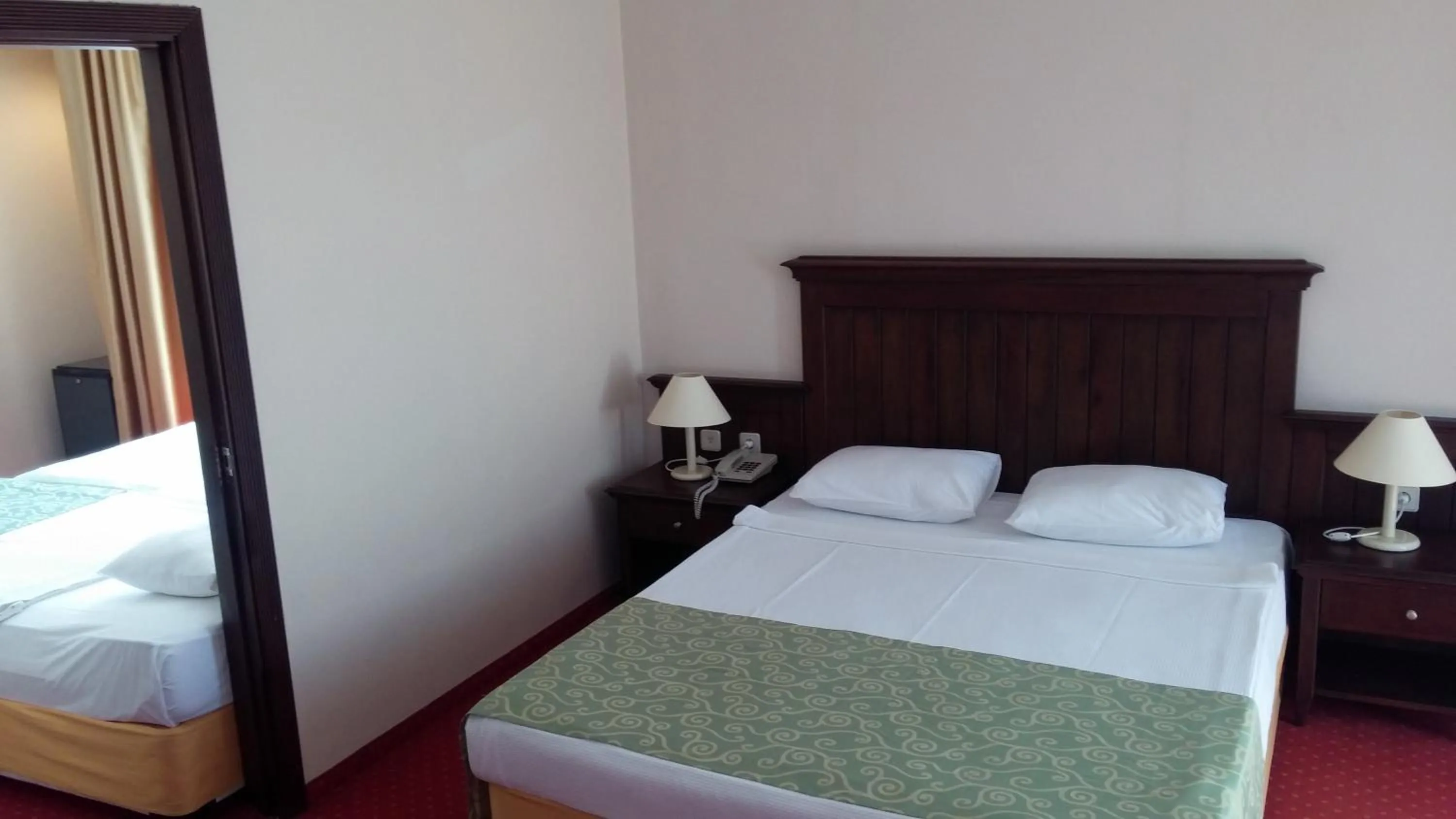 Bed in Side Palm D'or Hotel