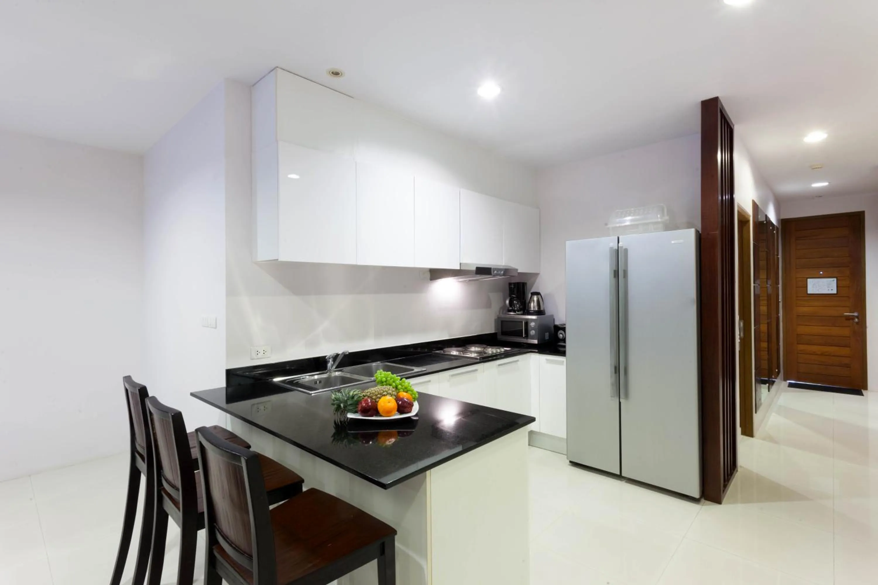 Kitchen or kitchenette in The Park Surin Serviced Apartments by RESAVA