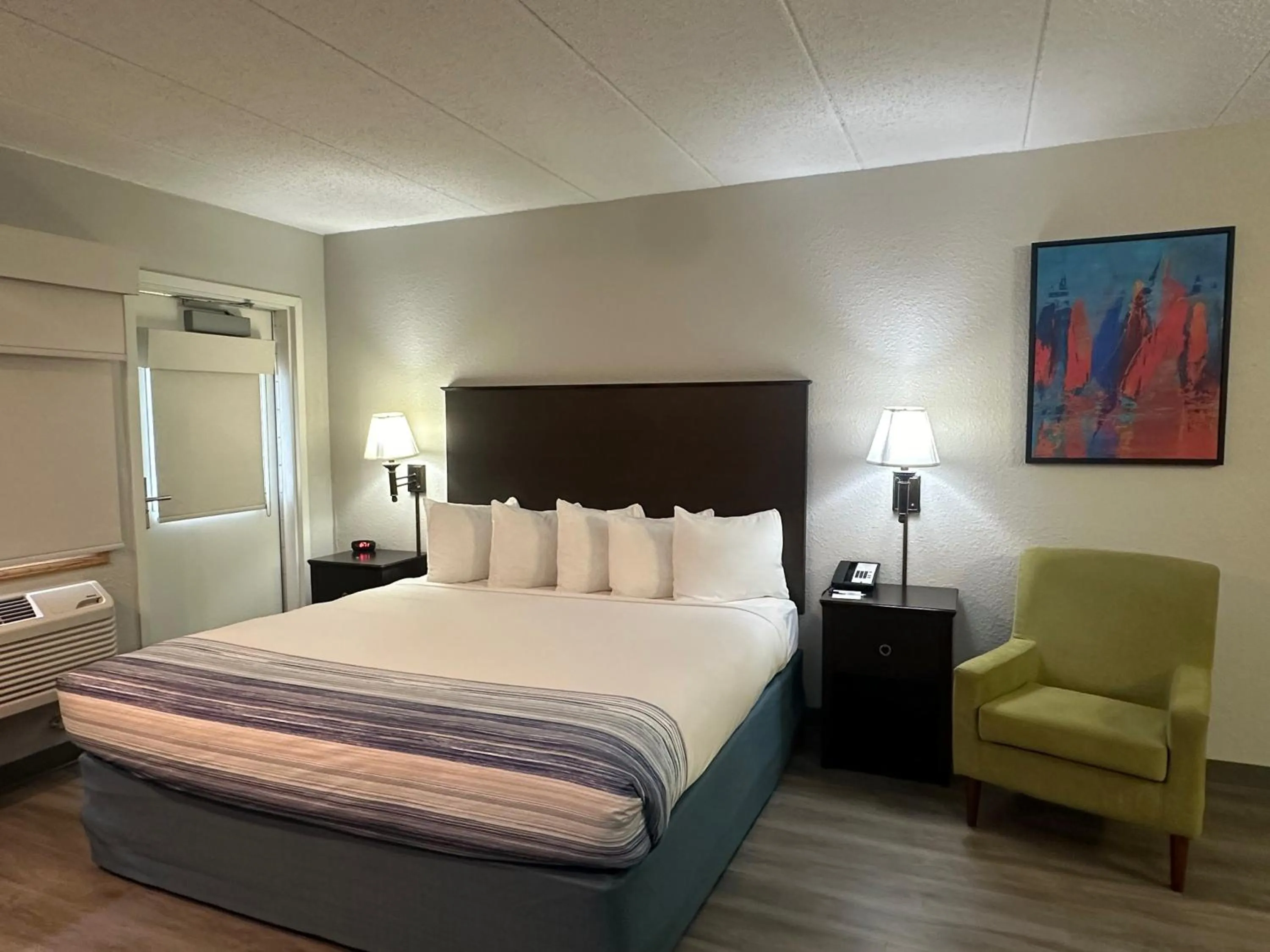 Bed in AmericInn by Wyndham Menominee