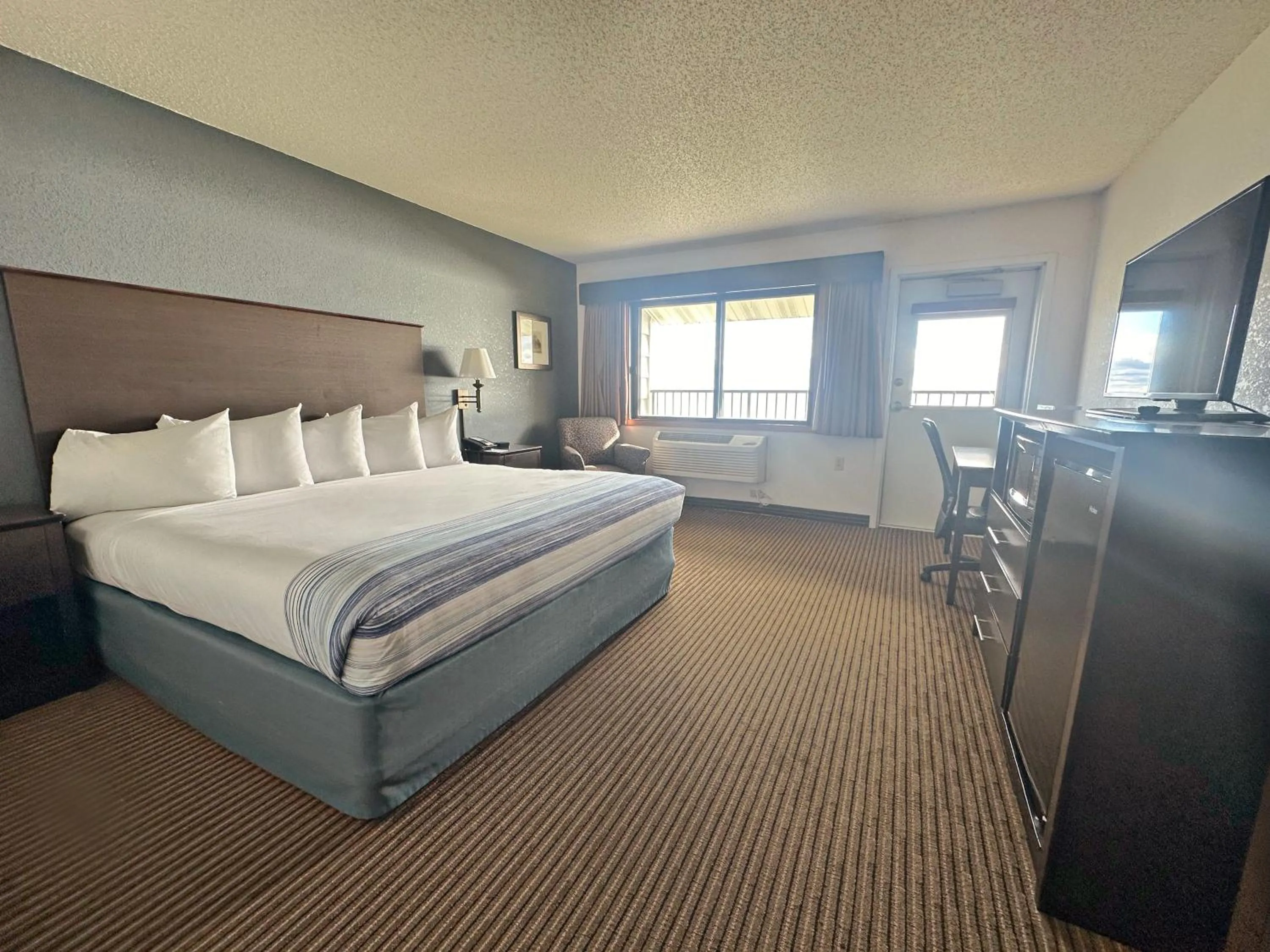 Bed in AmericInn by Wyndham Menominee