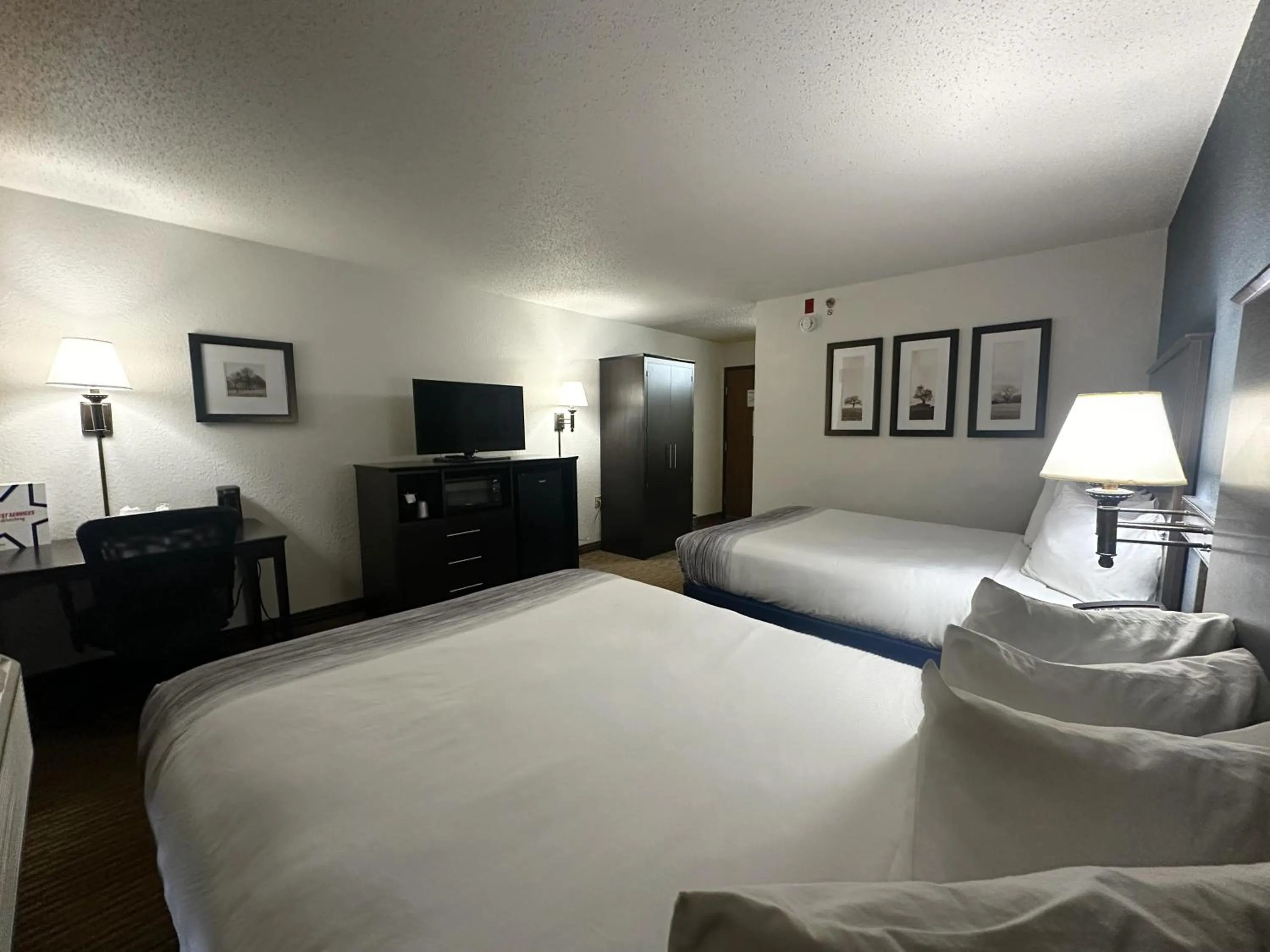 Bed in AmericInn by Wyndham Menominee