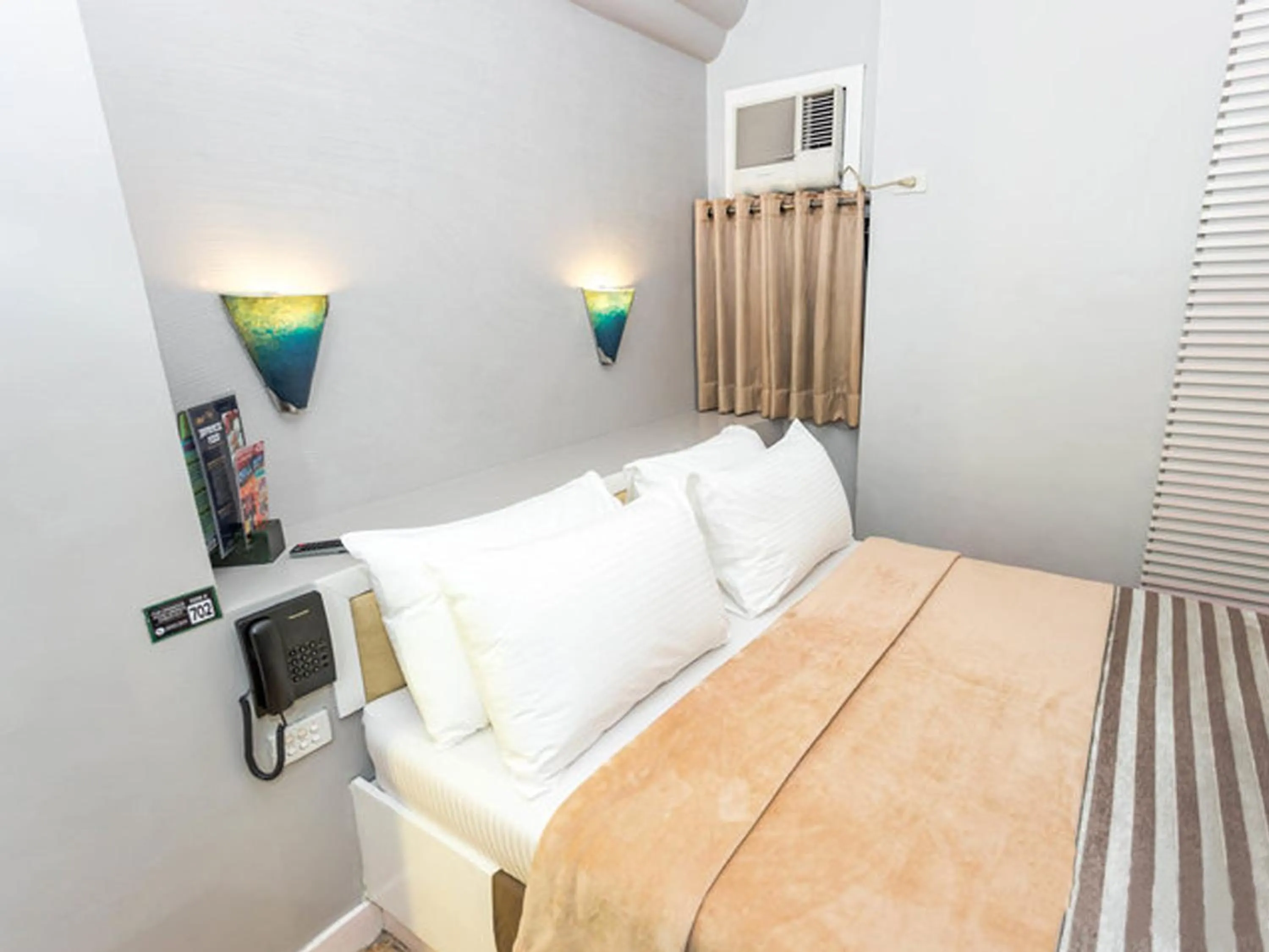 Bed in Urban Travellers Hotel