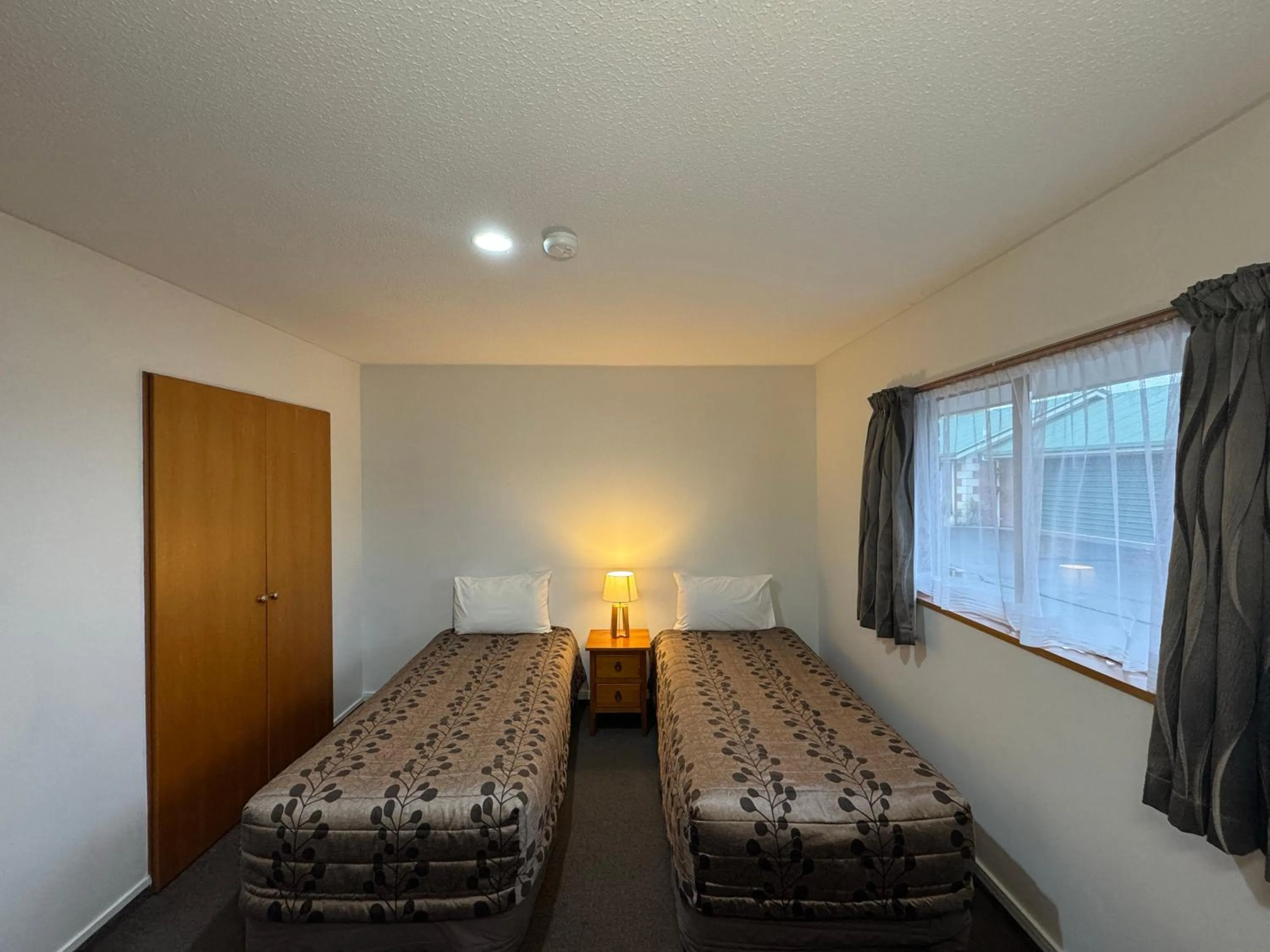 Bedroom, Bed in ASURE Ambassador Motor Lodge