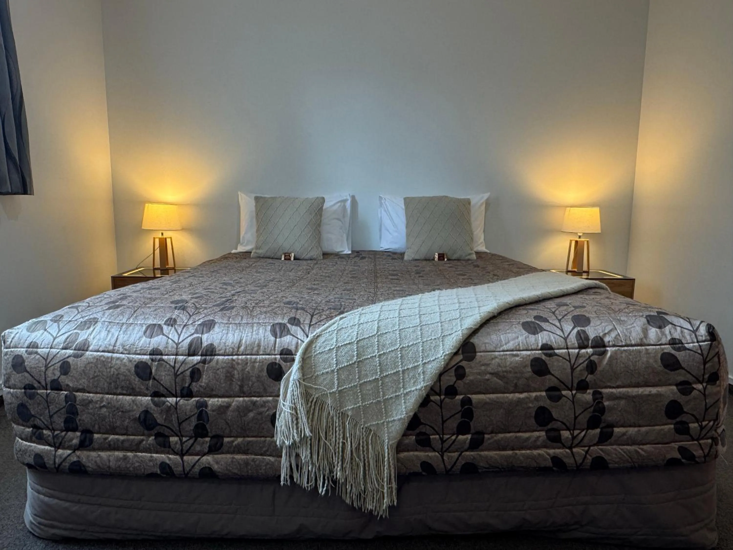 Bed in ASURE Ambassador Motor Lodge