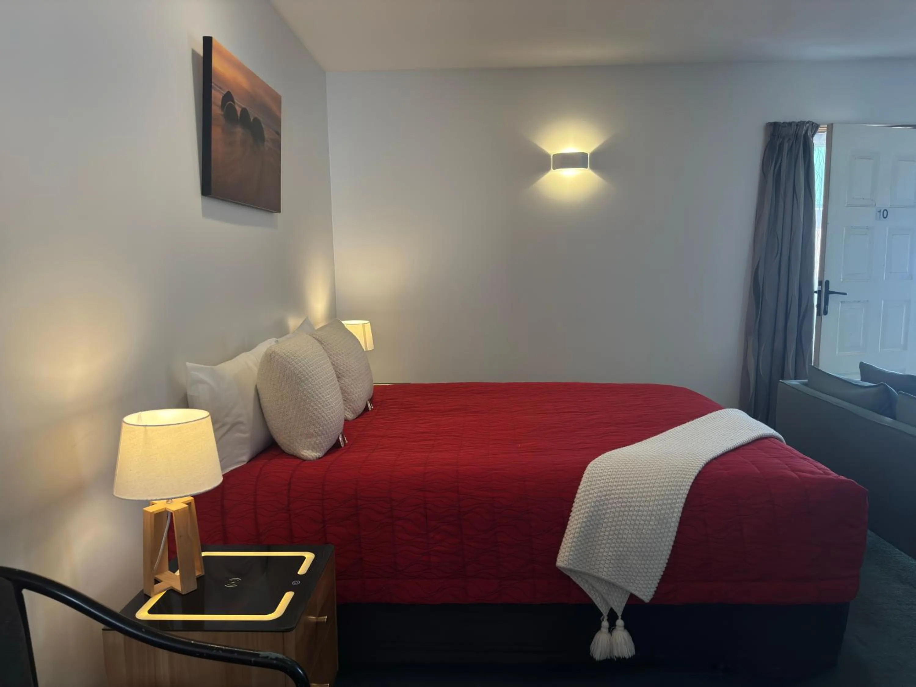 Bed in ASURE Ambassador Motor Lodge