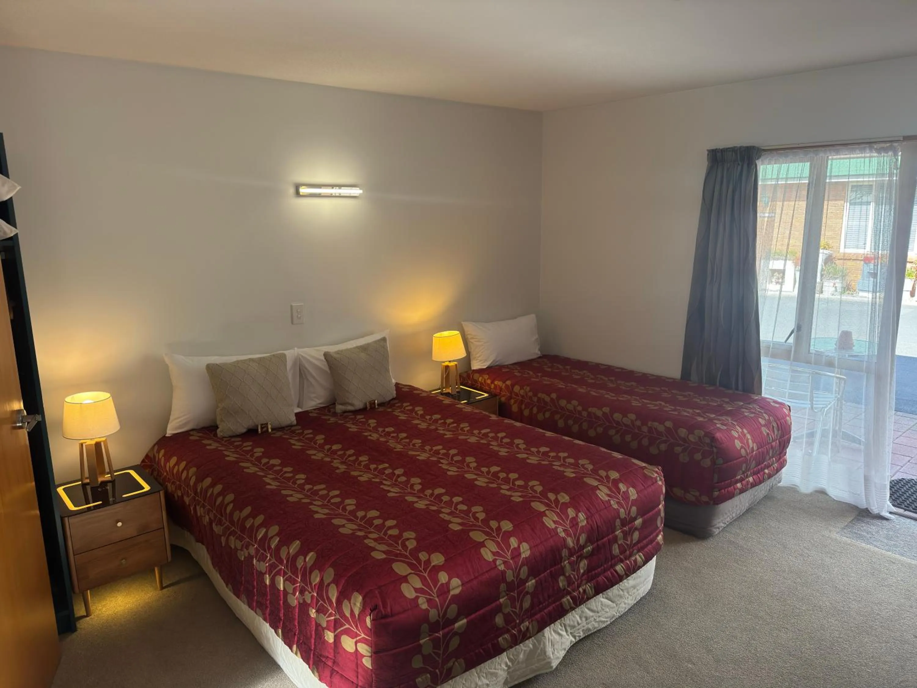 Bed in ASURE Ambassador Motor Lodge