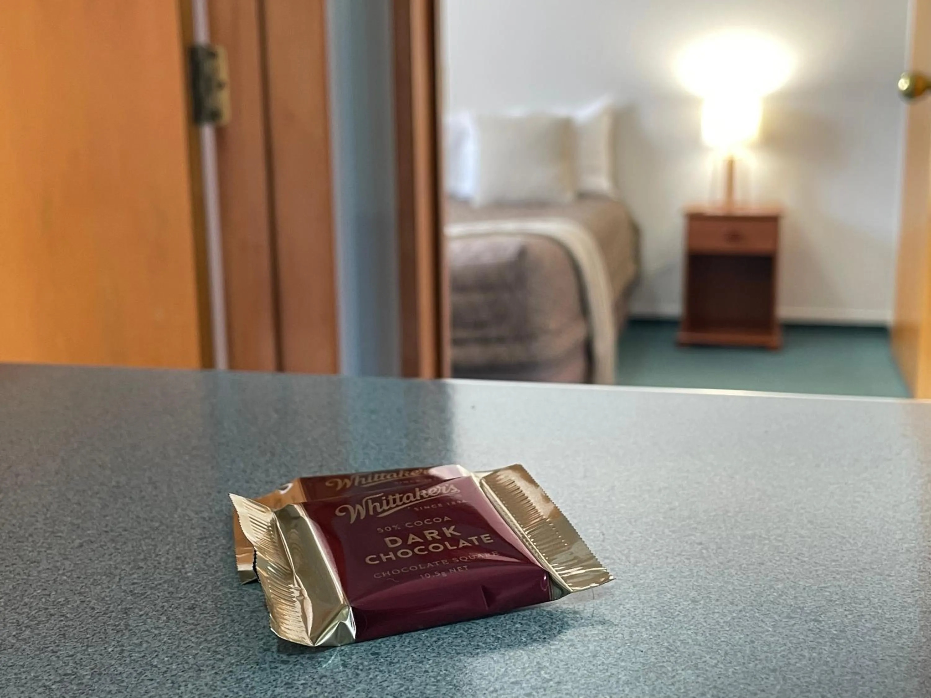 Bed in ASURE Ambassador Motor Lodge