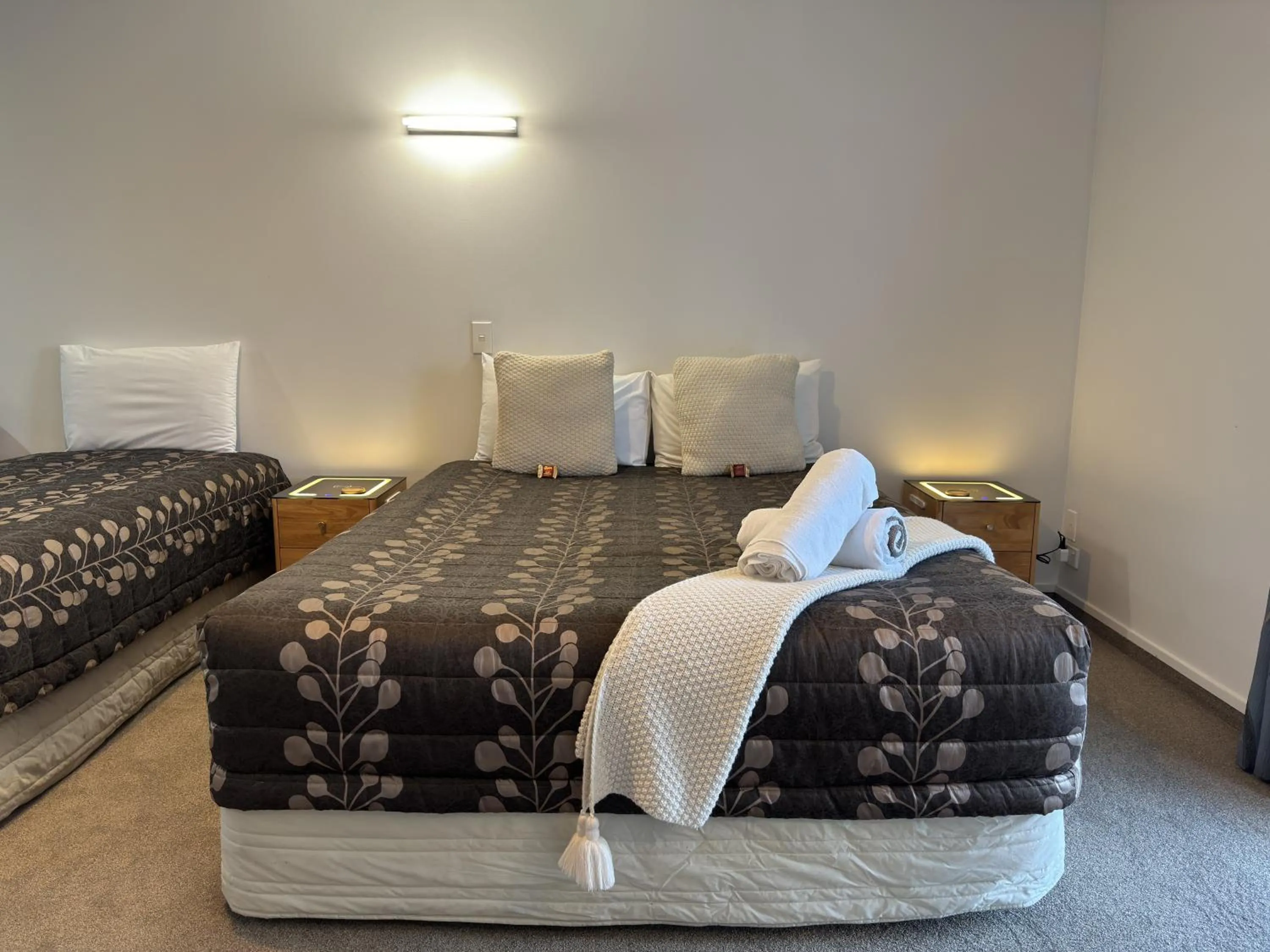 Bed in ASURE Ambassador Motor Lodge