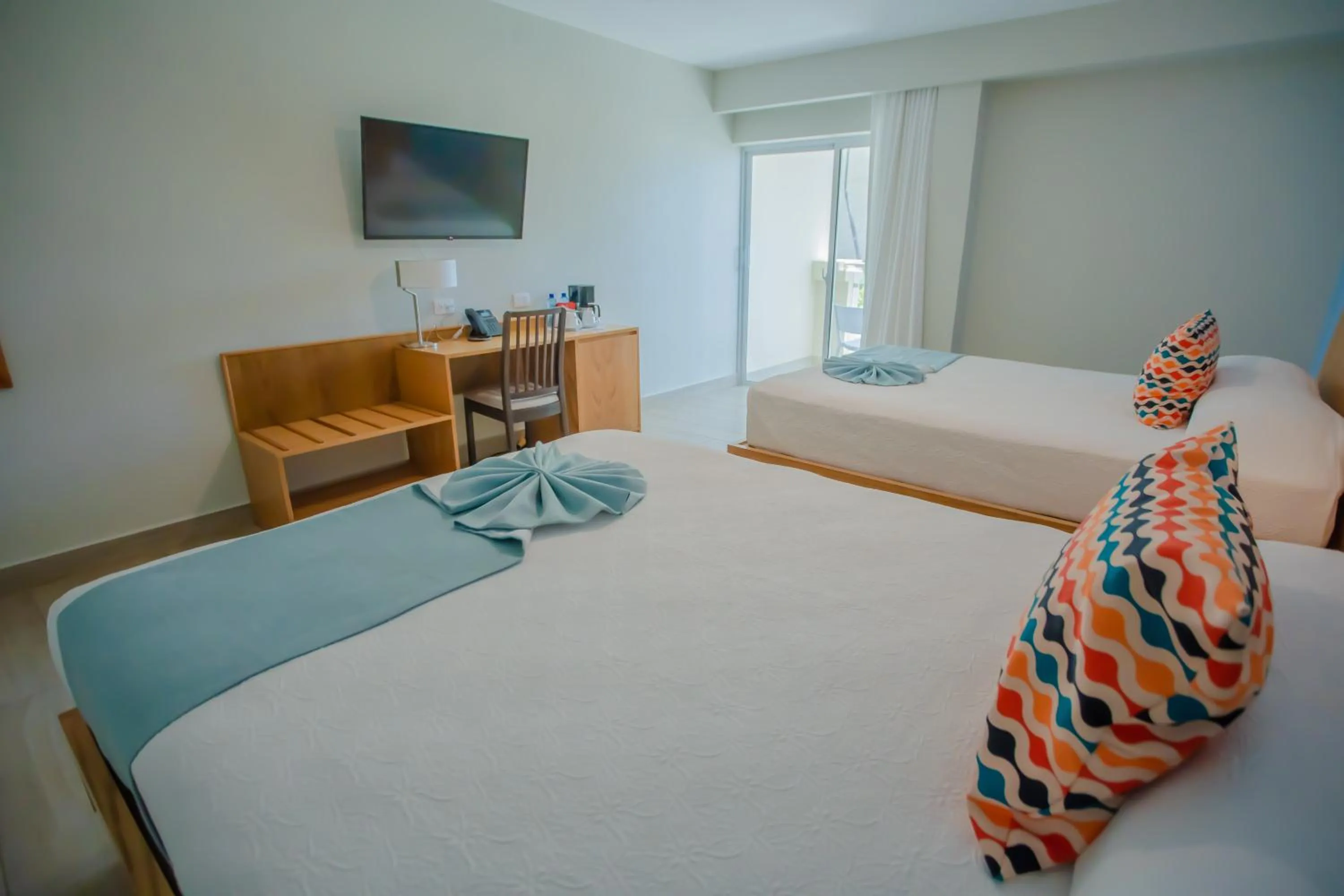 Bed in Coral Costa Caribe Beach Resort - All Inclusive