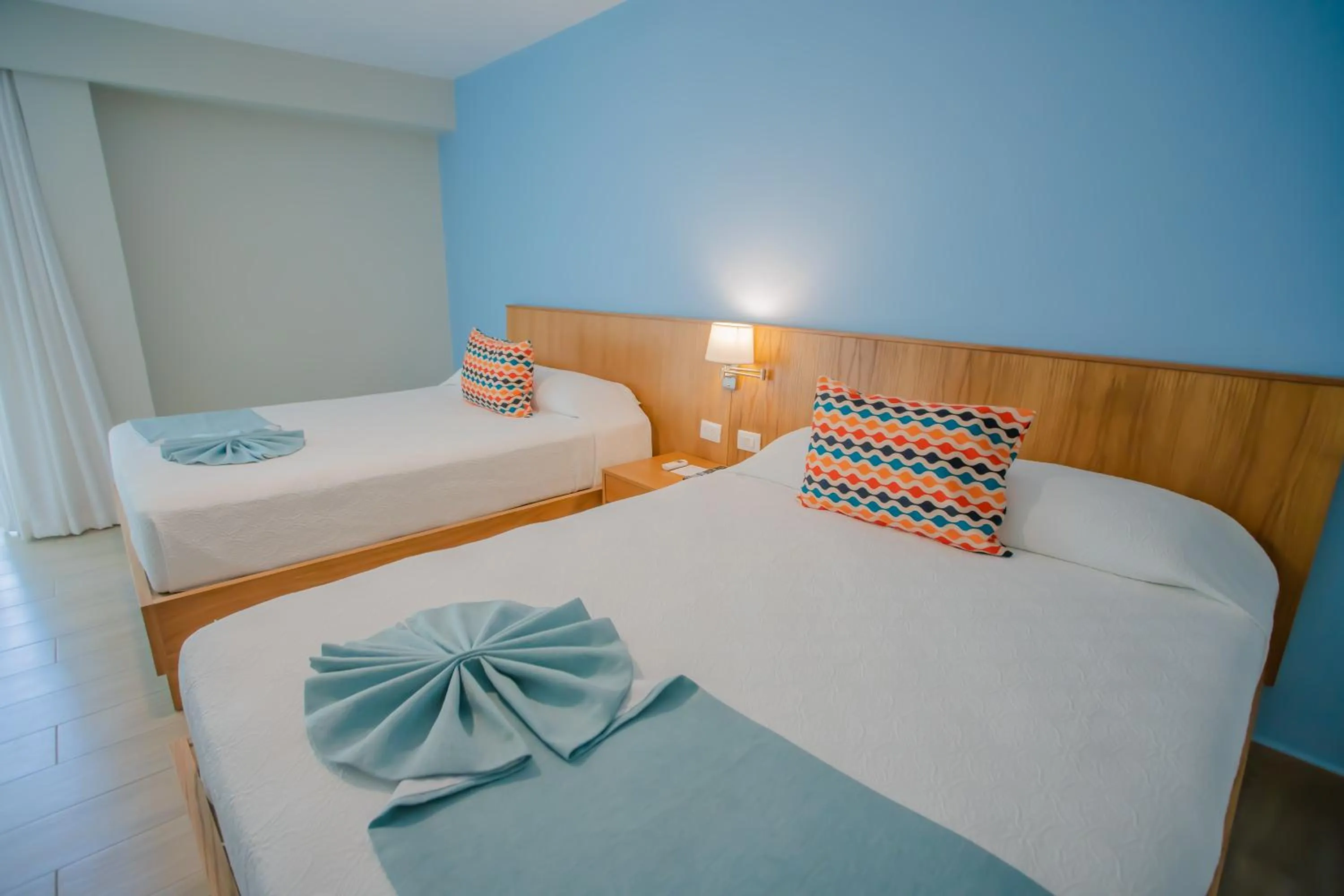 Bed in Coral Costa Caribe Beach Resort - All Inclusive