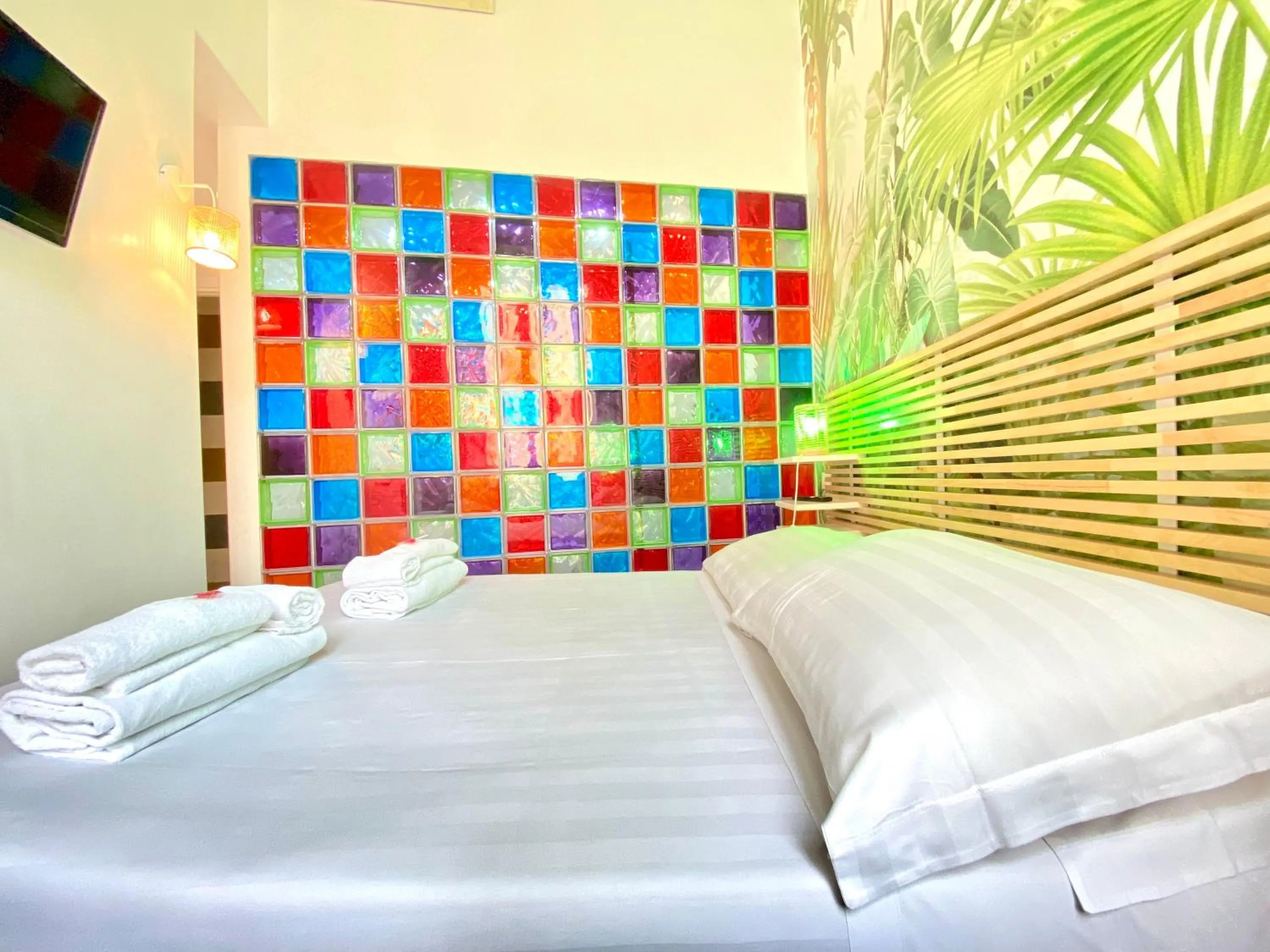 Bed in KISS ME ROME Luxury Rooms