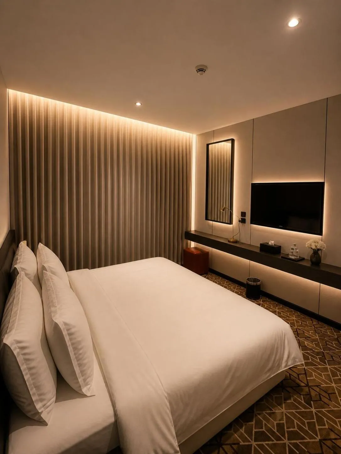 Bed in LeChateau Boutique Hotel