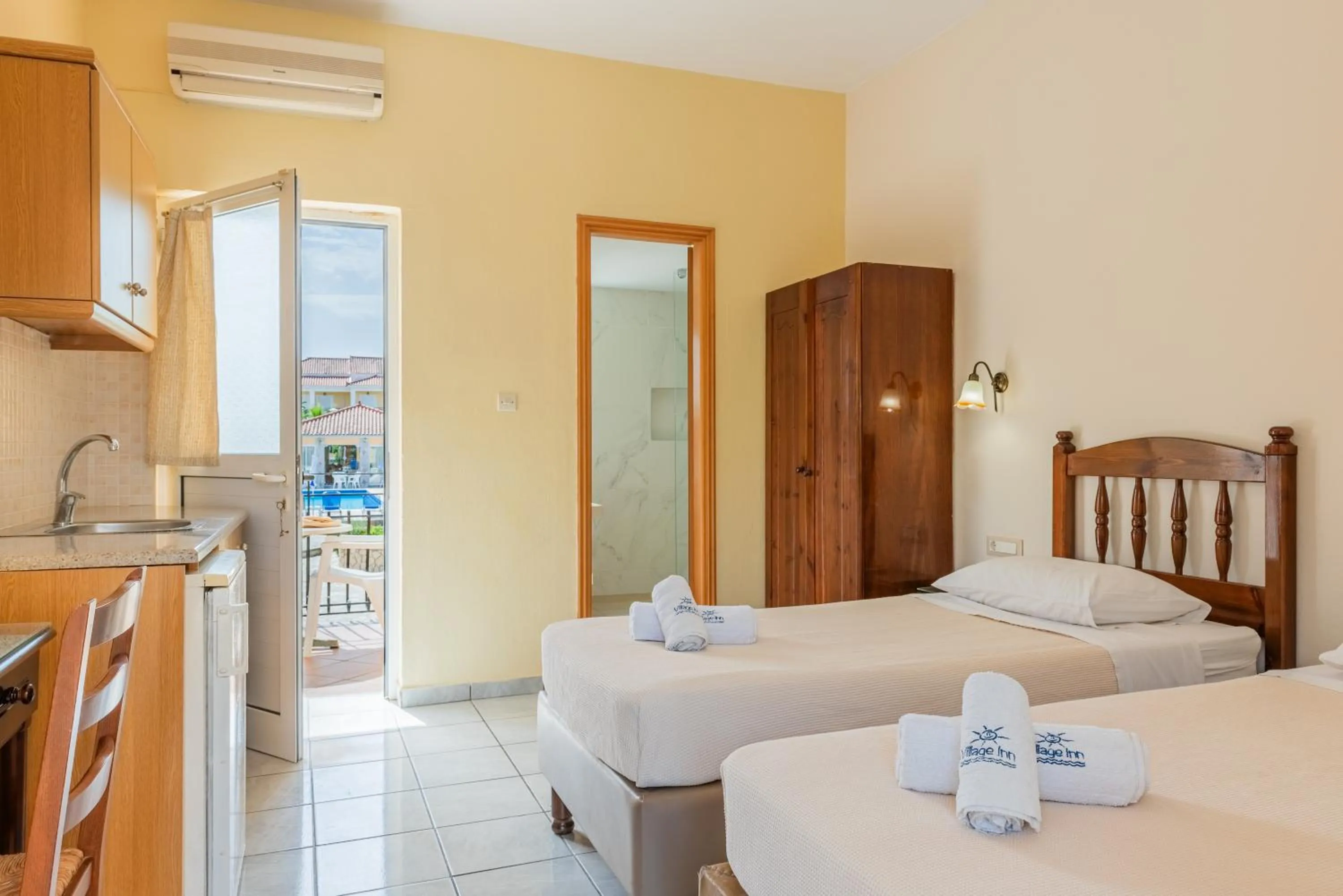 Bed in Village Inn Studios & Family Apartments