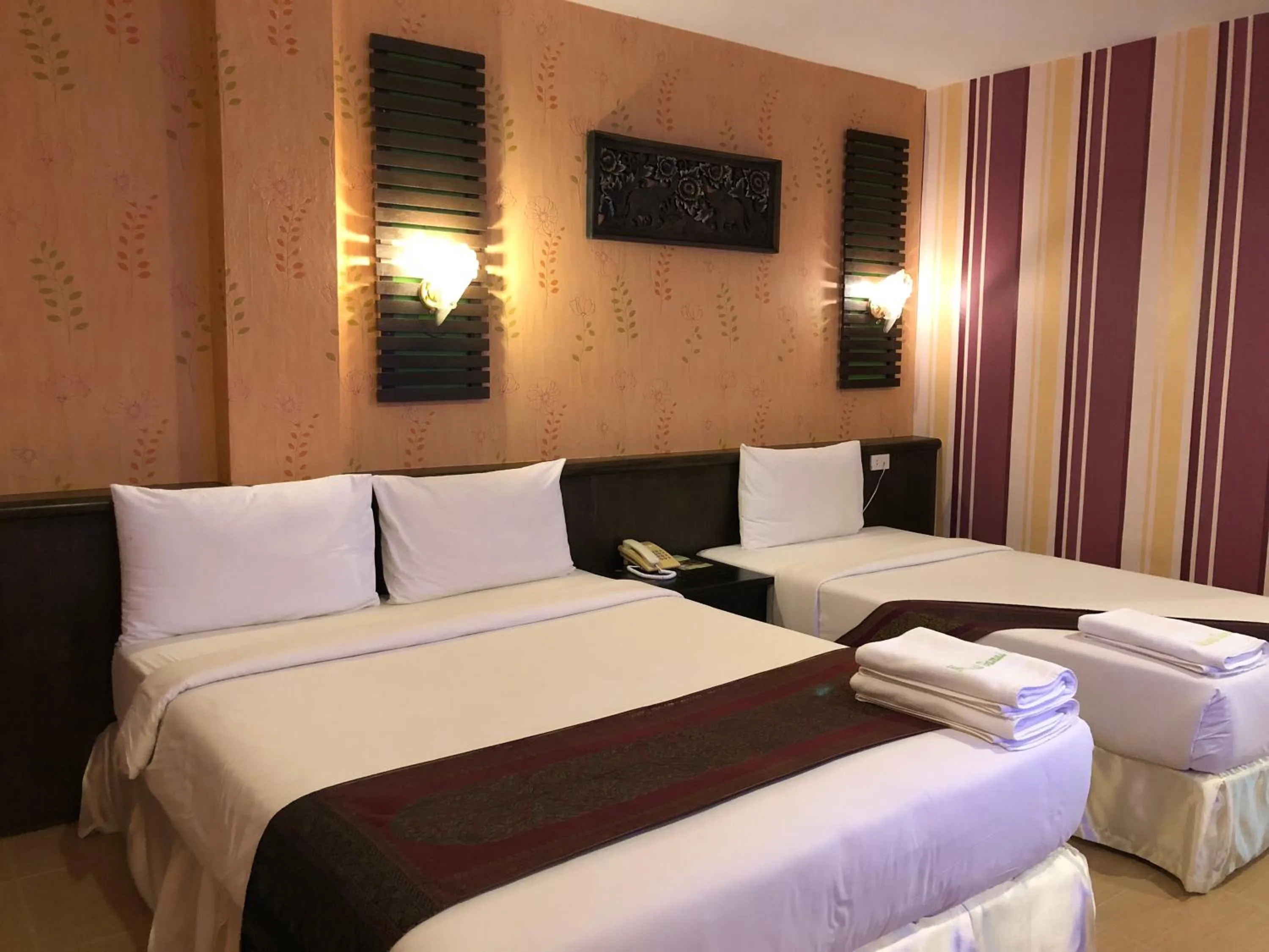 Bed in Natural Samui Hotel