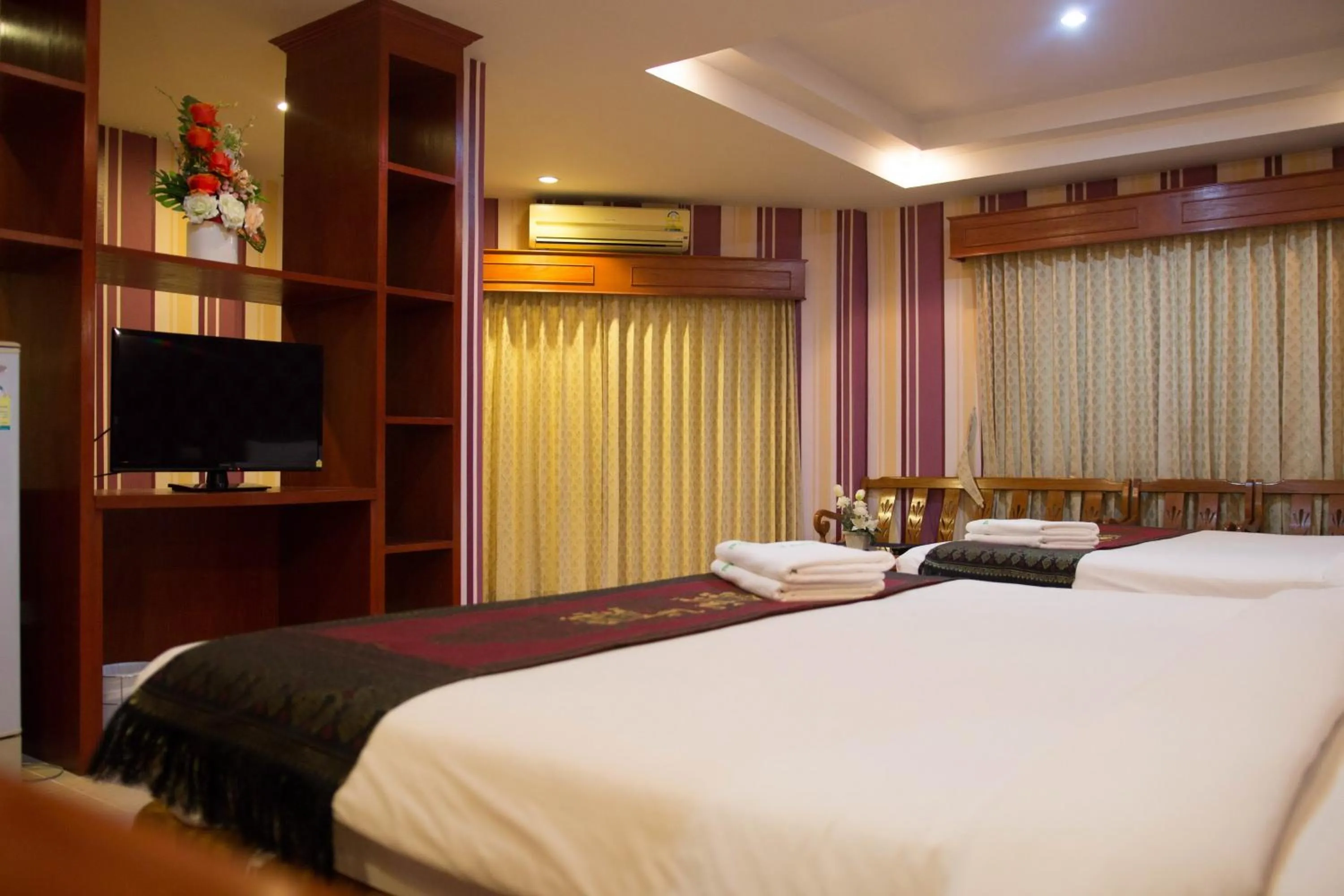 Bed in Natural Samui Hotel