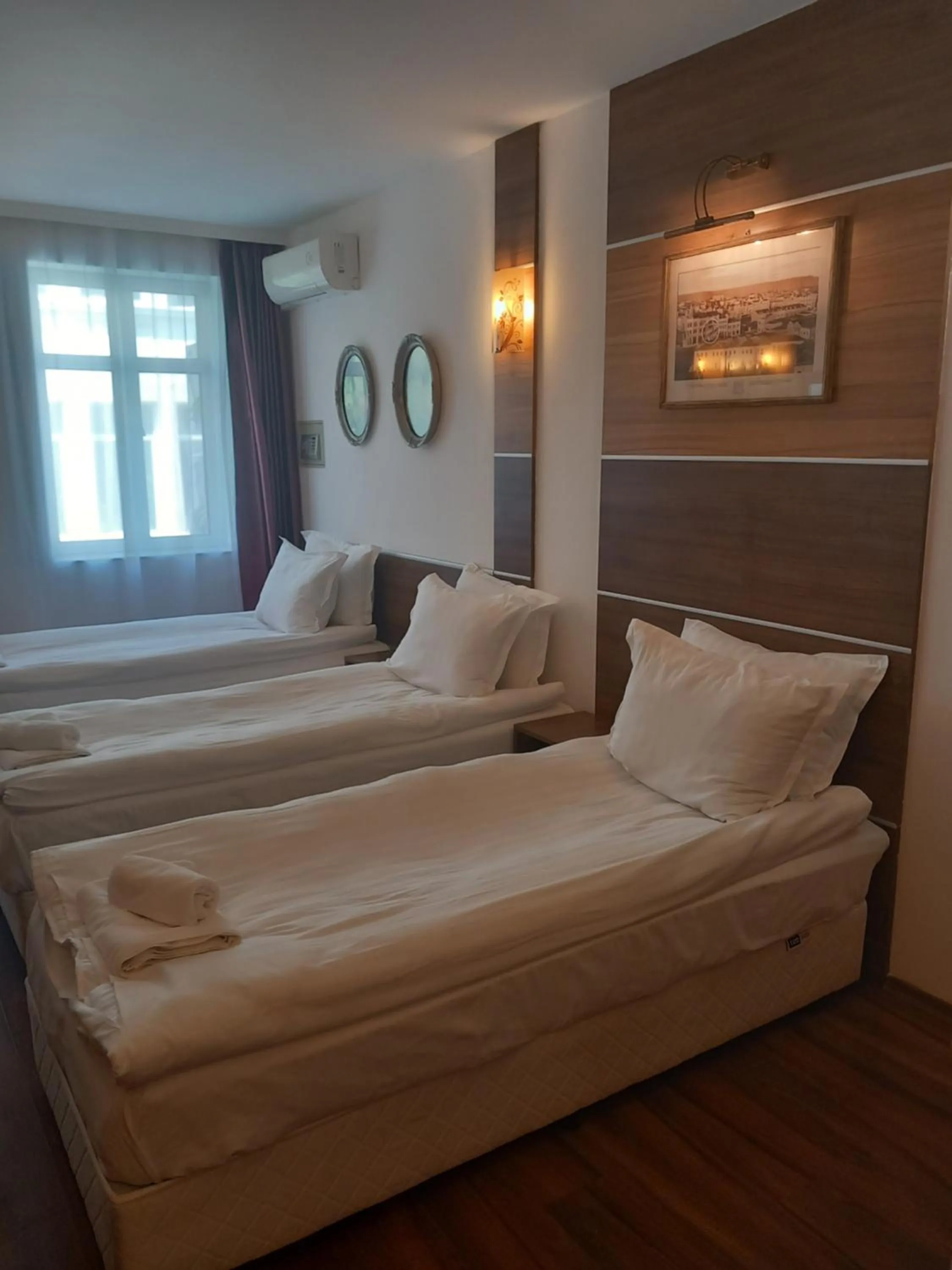 Bed in Three Dolphins Hotel with a Rooftop terracе