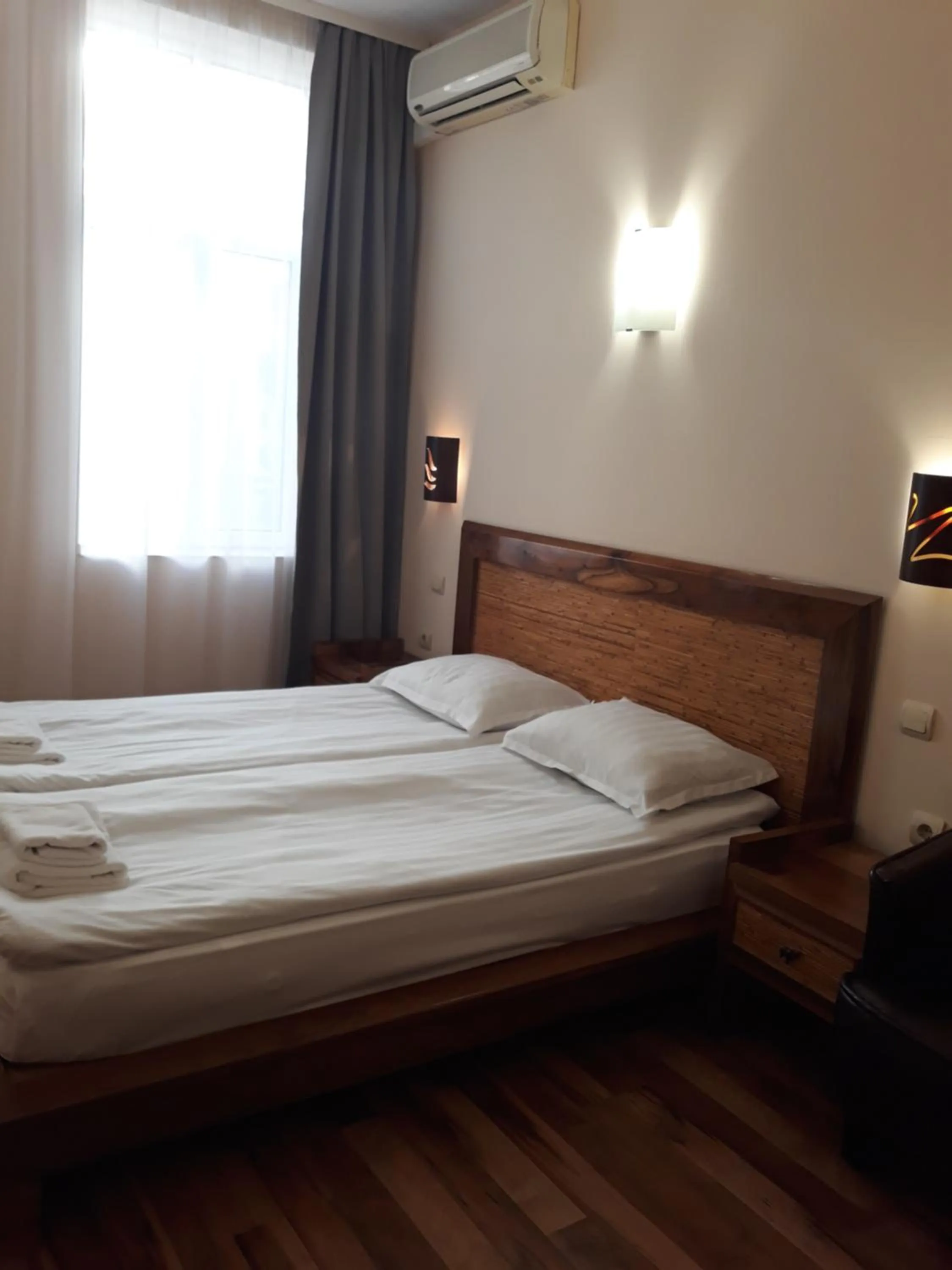 Bed in Three Dolphins Hotel with a Rooftop terracе