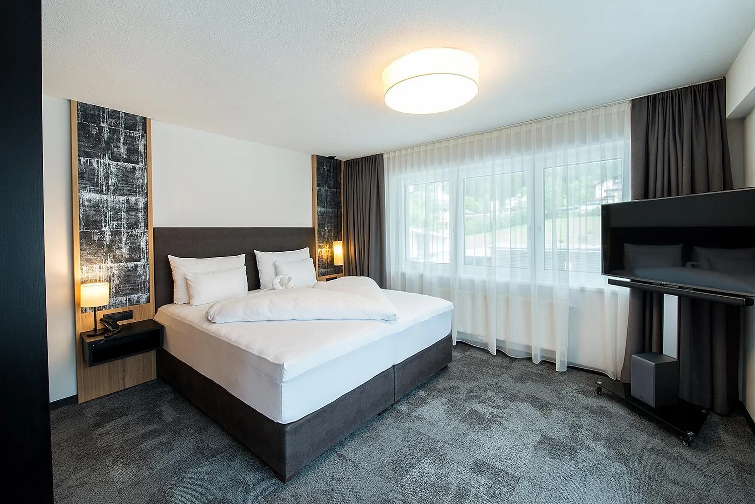 Bed in Arthur's Hotel und Apartments am Achensee