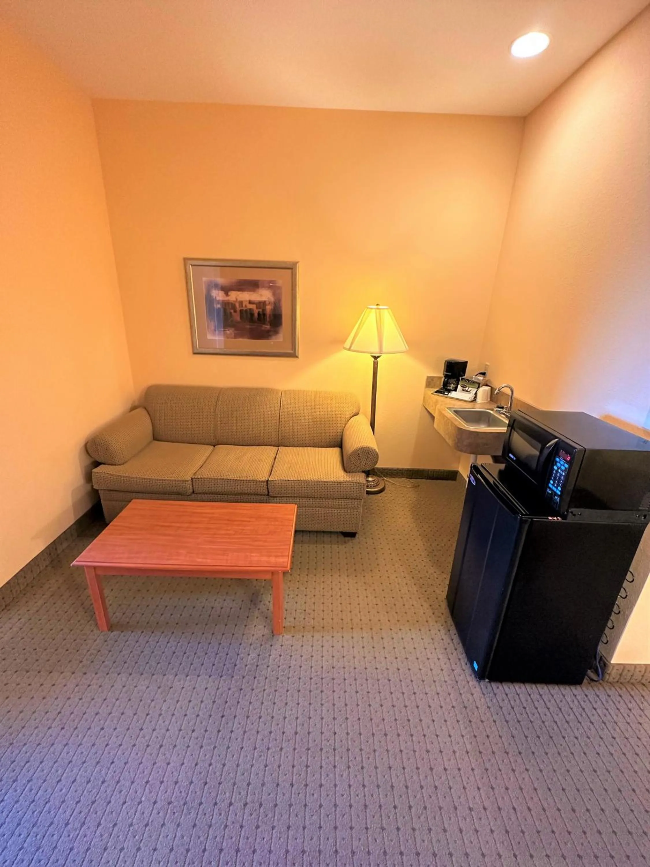 Living room in Super 8 by Wyndham Topeka at Forbes Landing