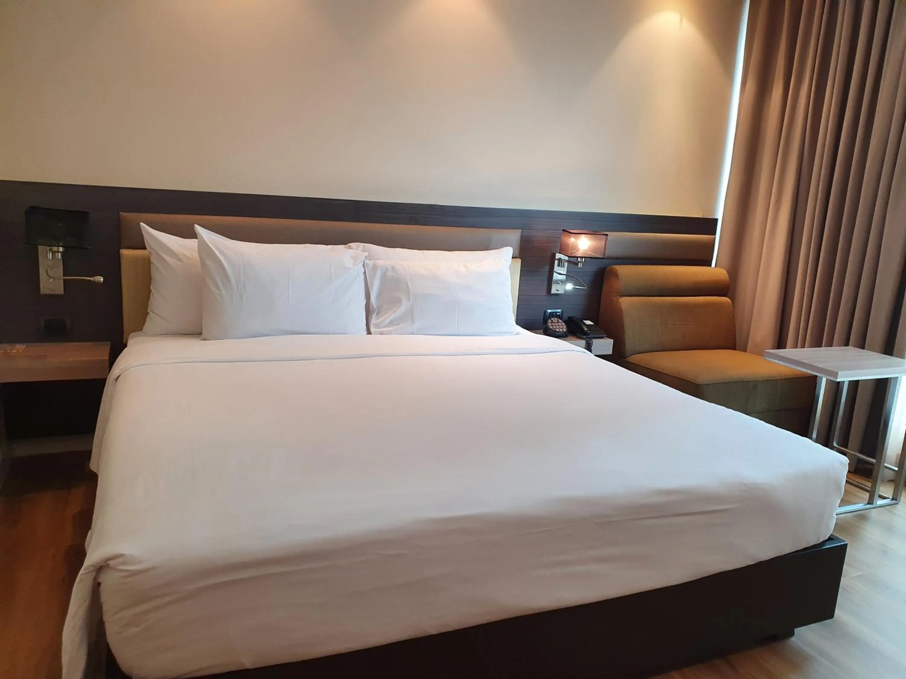 Bed in Amora NeoLuxe Suites Hotel