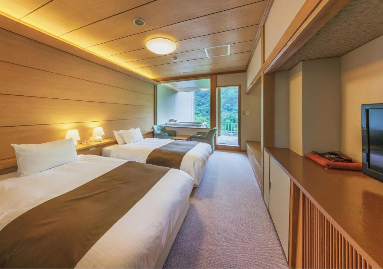 Bed in Marumine Kanko Hotel