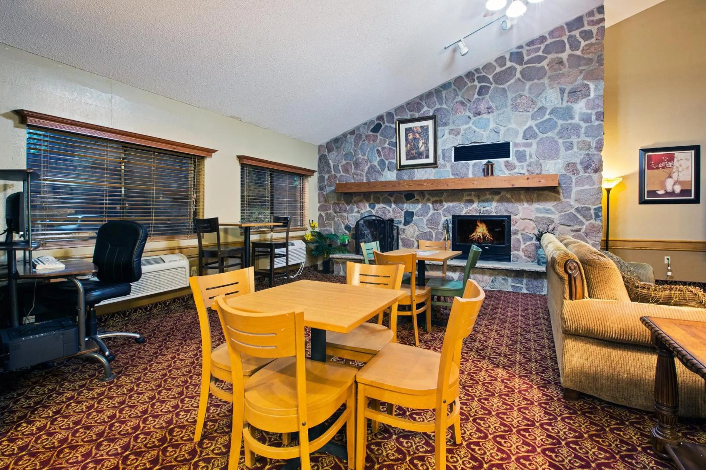 Communal lounge/ TV room in AmericInn by Wyndham Ham Lake