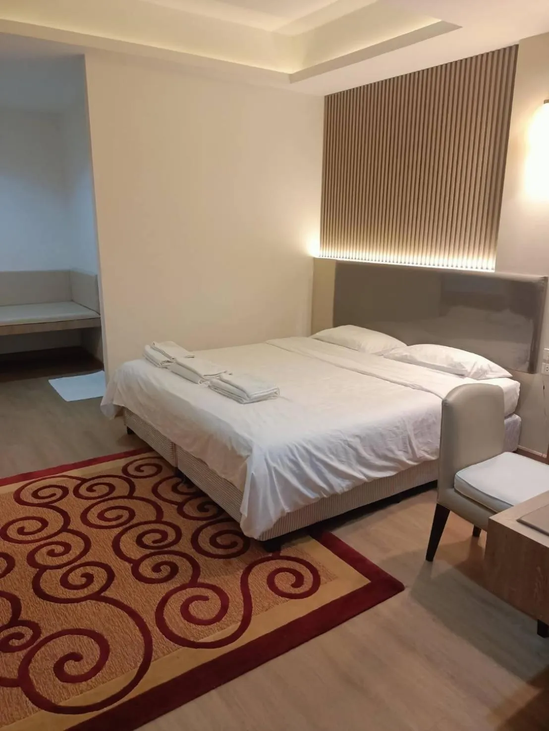 Bed in Royal Garden Home Hotel