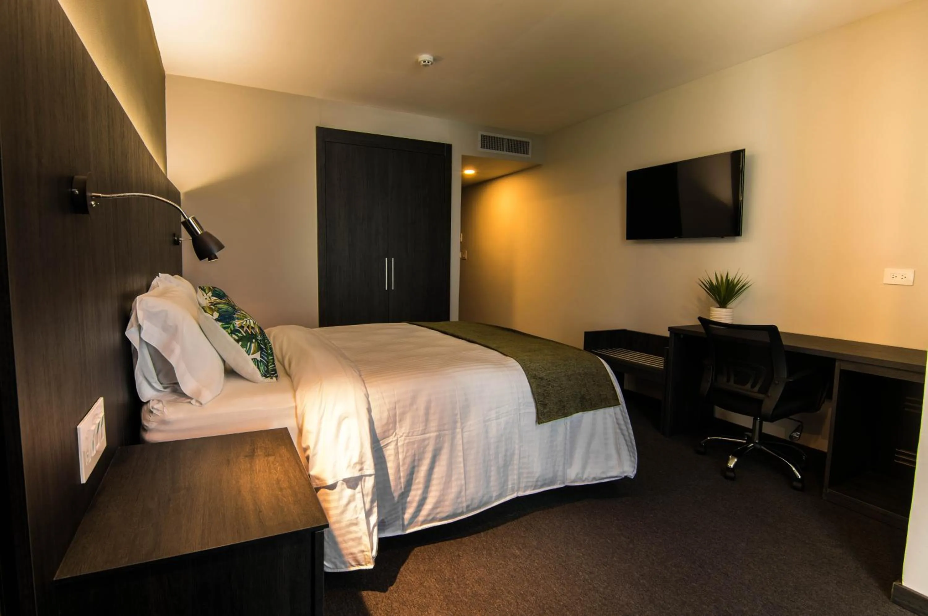 Bed in Innfiniti Hotel & Suites