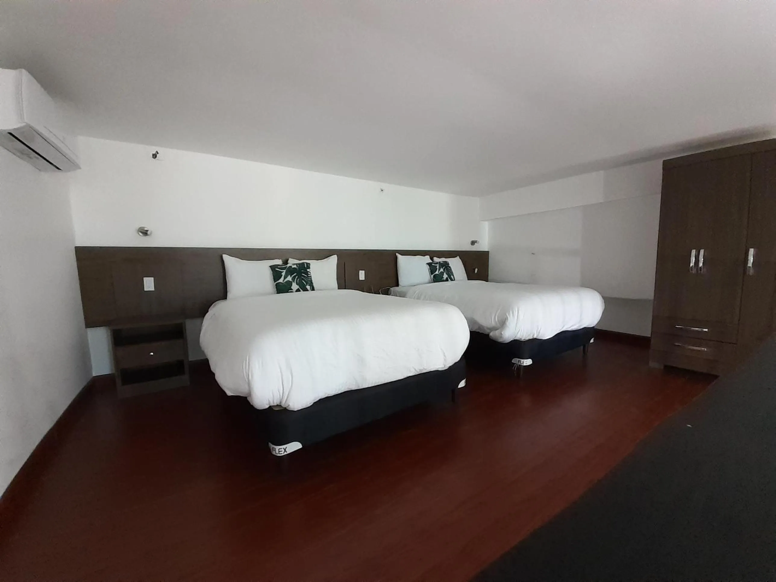 Bed in Innfiniti Hotel & Suites