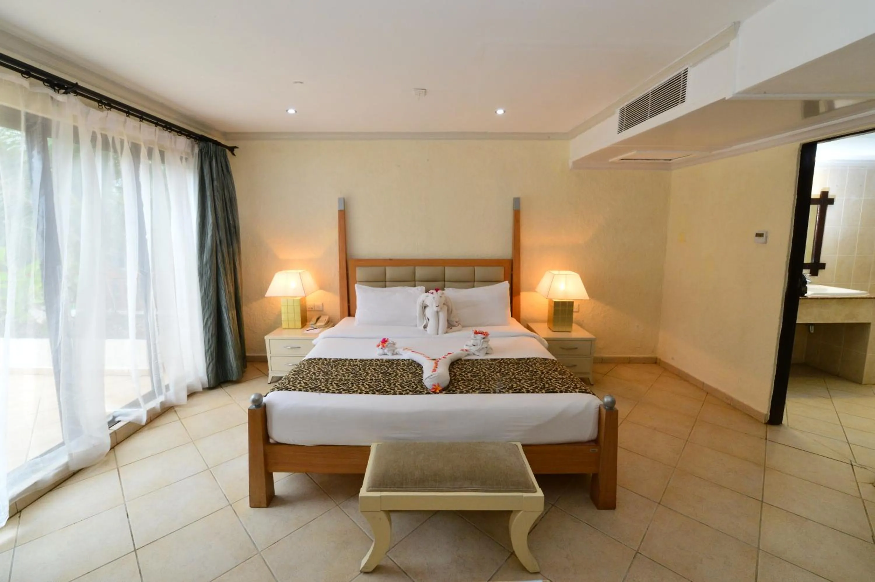 Bedroom, Bed in Diani Reef Beach Resort & Spa - Your Beachfront Bliss Awaits