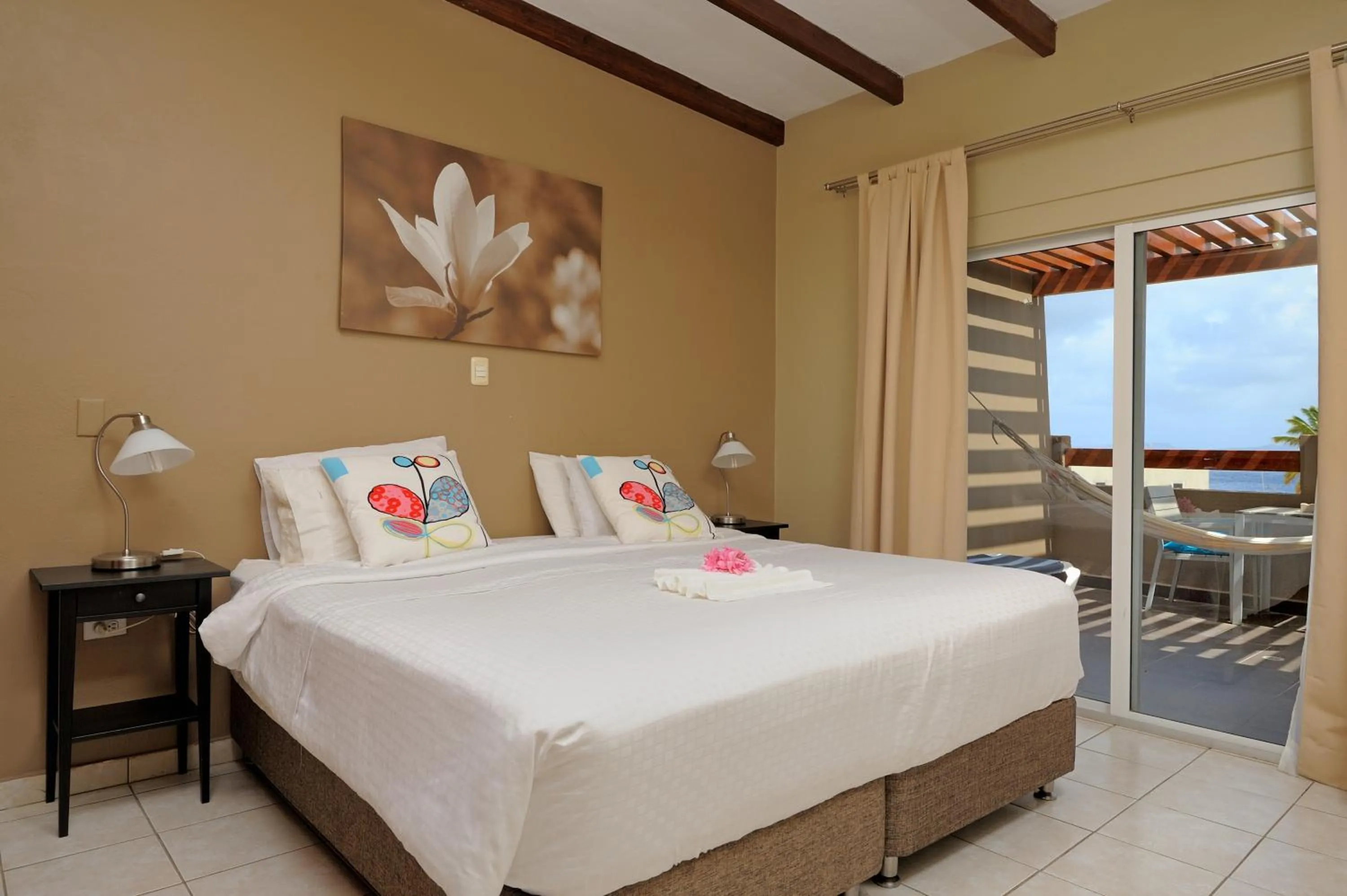 Balcony/Terrace, Bed in Eden Beach Resort - Bonaire