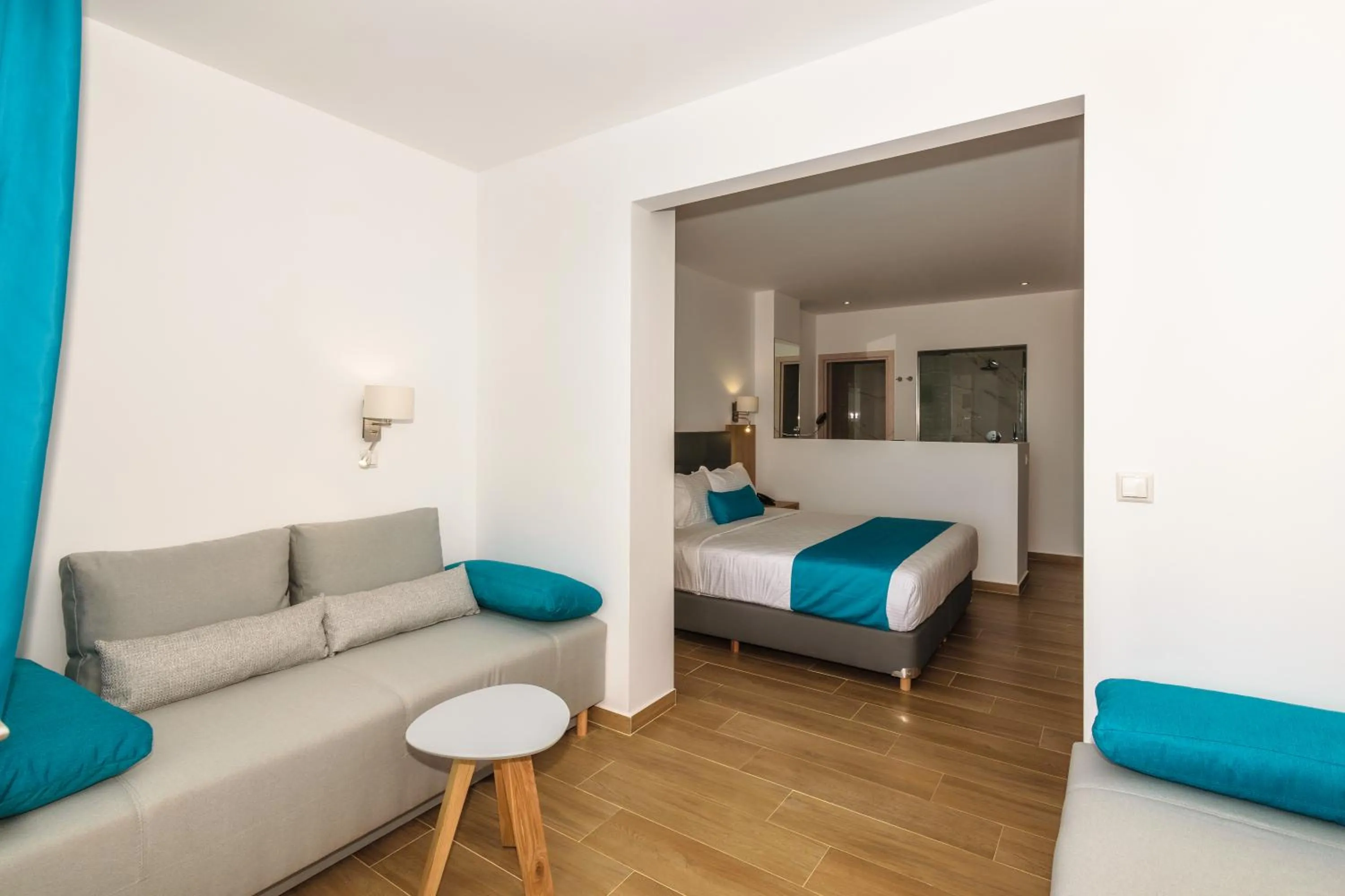 Seating area, Bed in Cavo Orient Beach Hotel & Suites