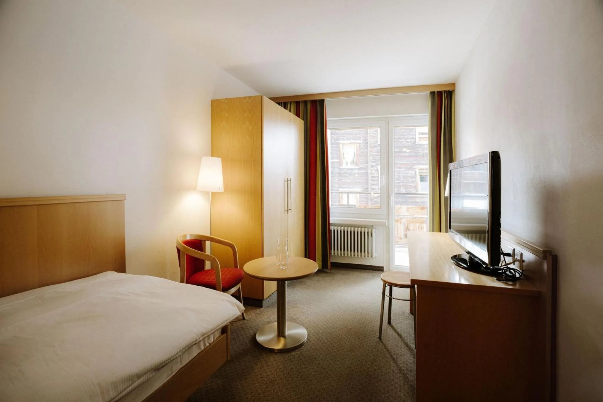 Seating area, Bed in Alpine Hotel Perren