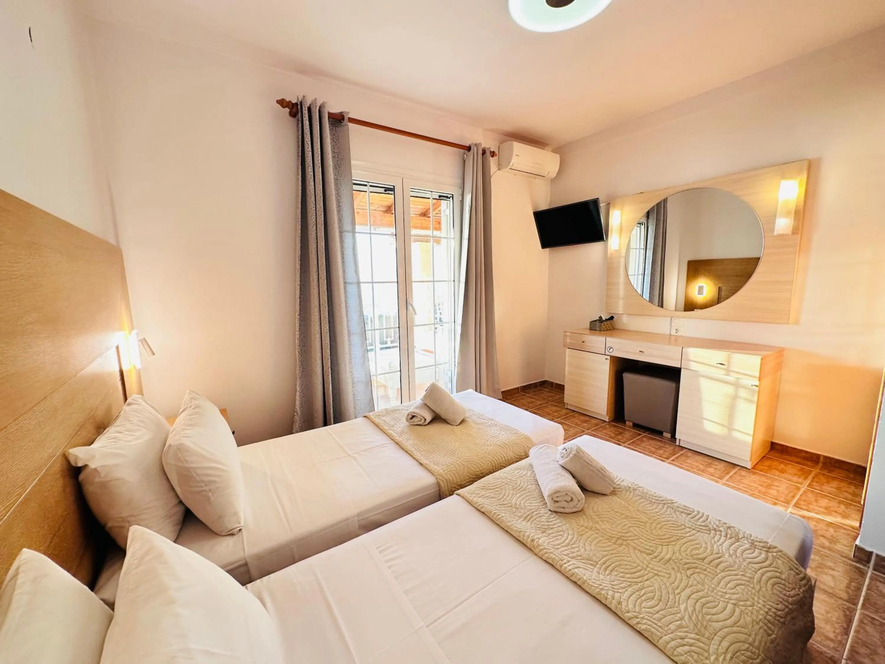 TV and multimedia, Bed in Nikos Apartments Corfu