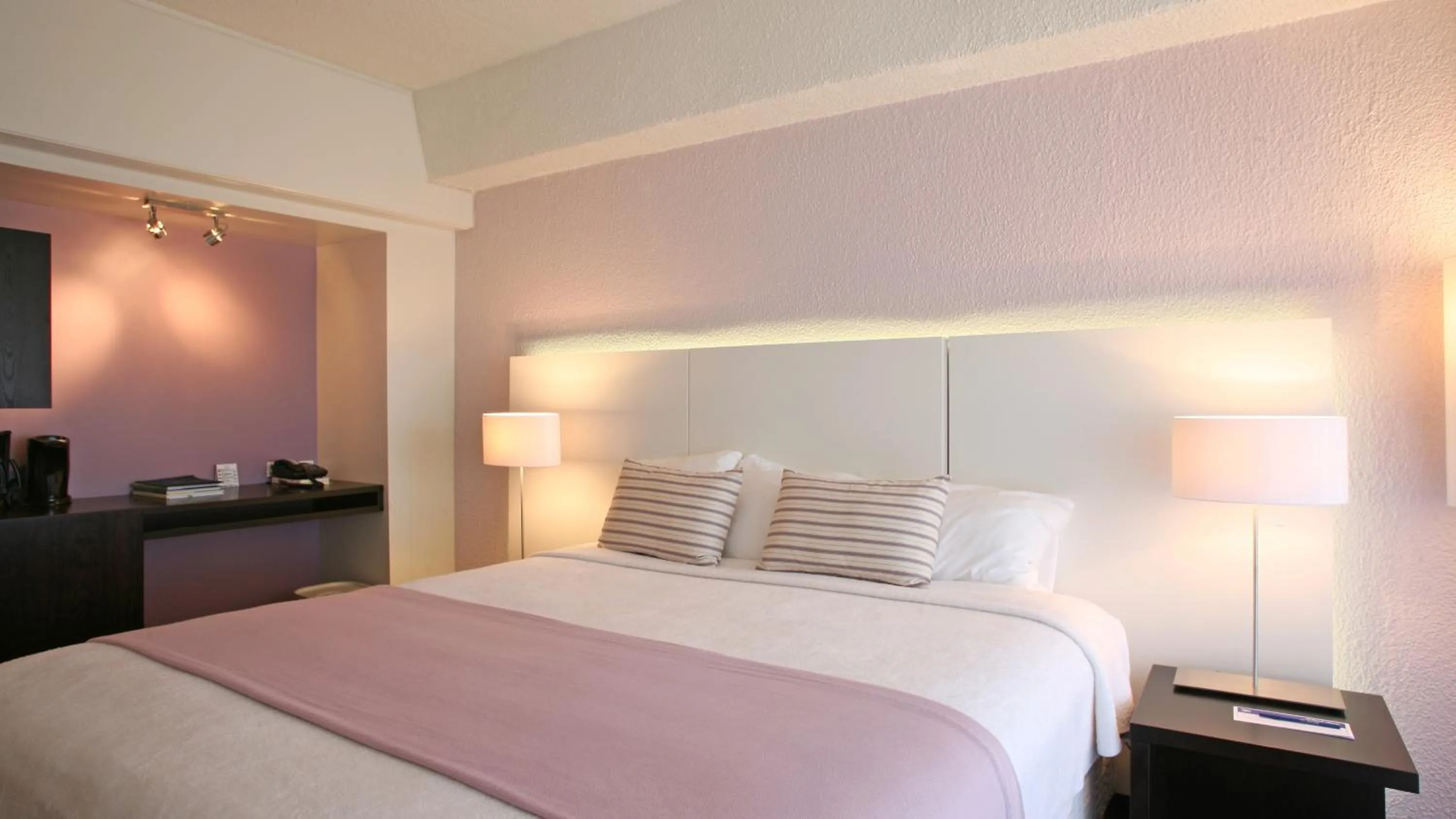 Bed in Holland House Beach Hotel