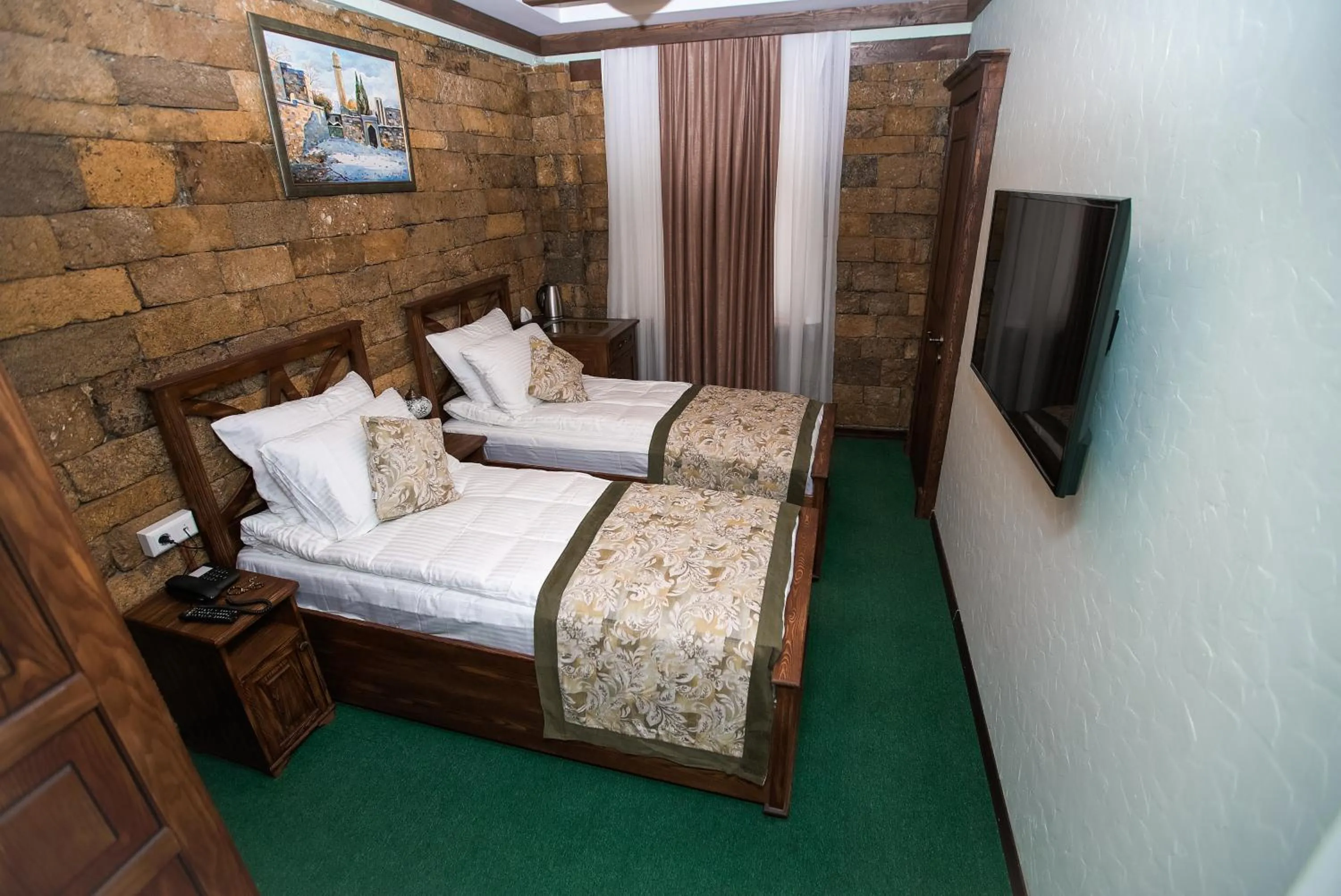 Bed in Maajid Boutique Hotel
