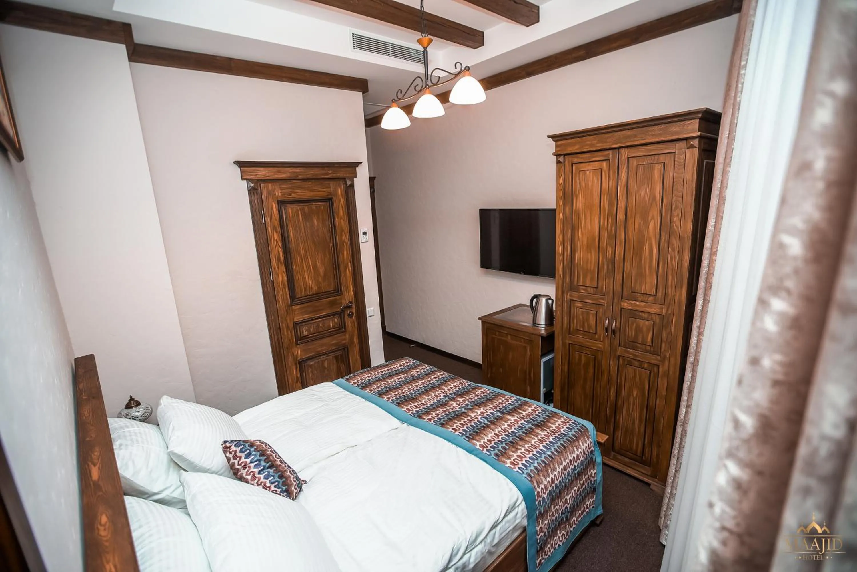 Bed in Maajid Boutique Hotel