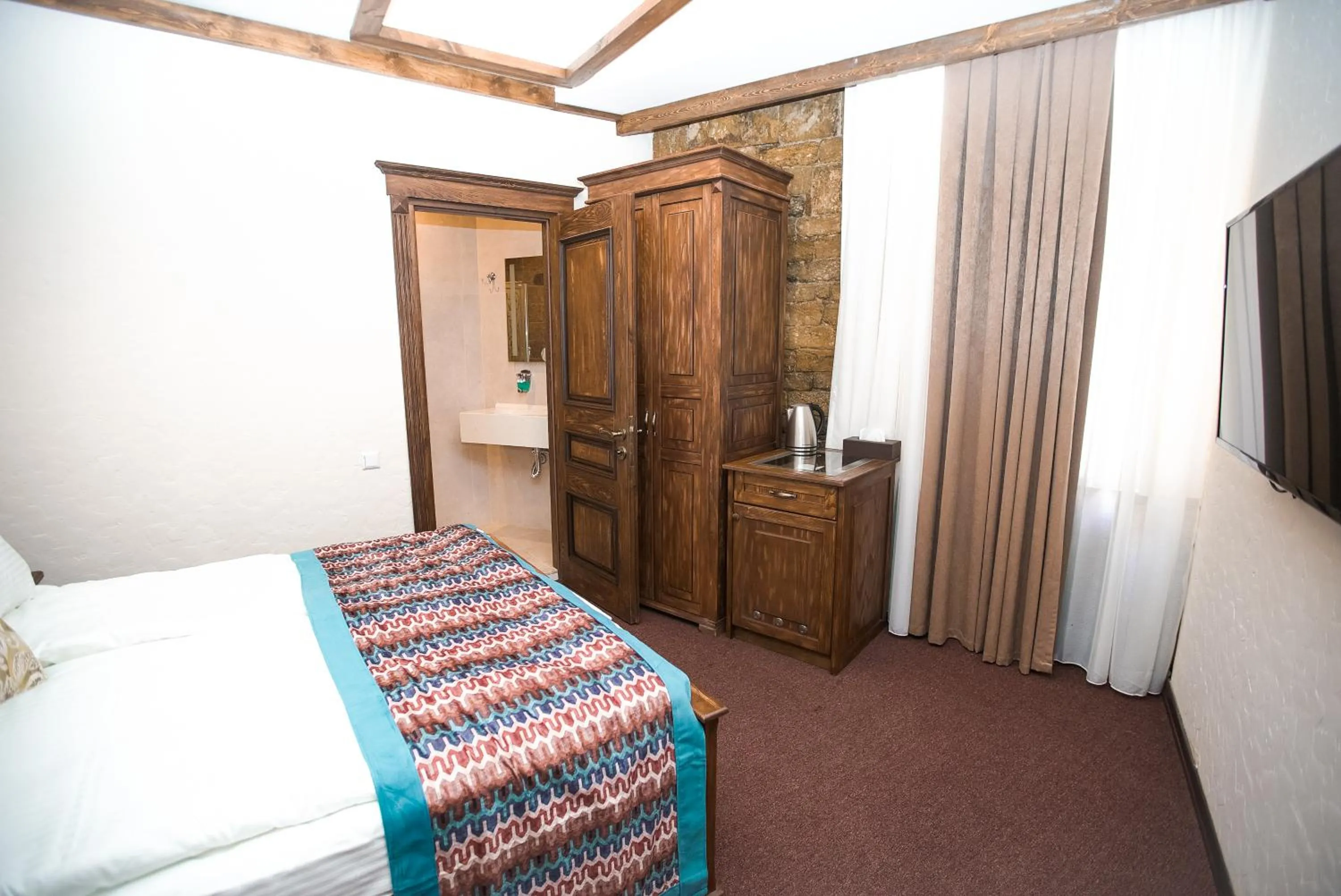 Bed in Maajid Boutique Hotel