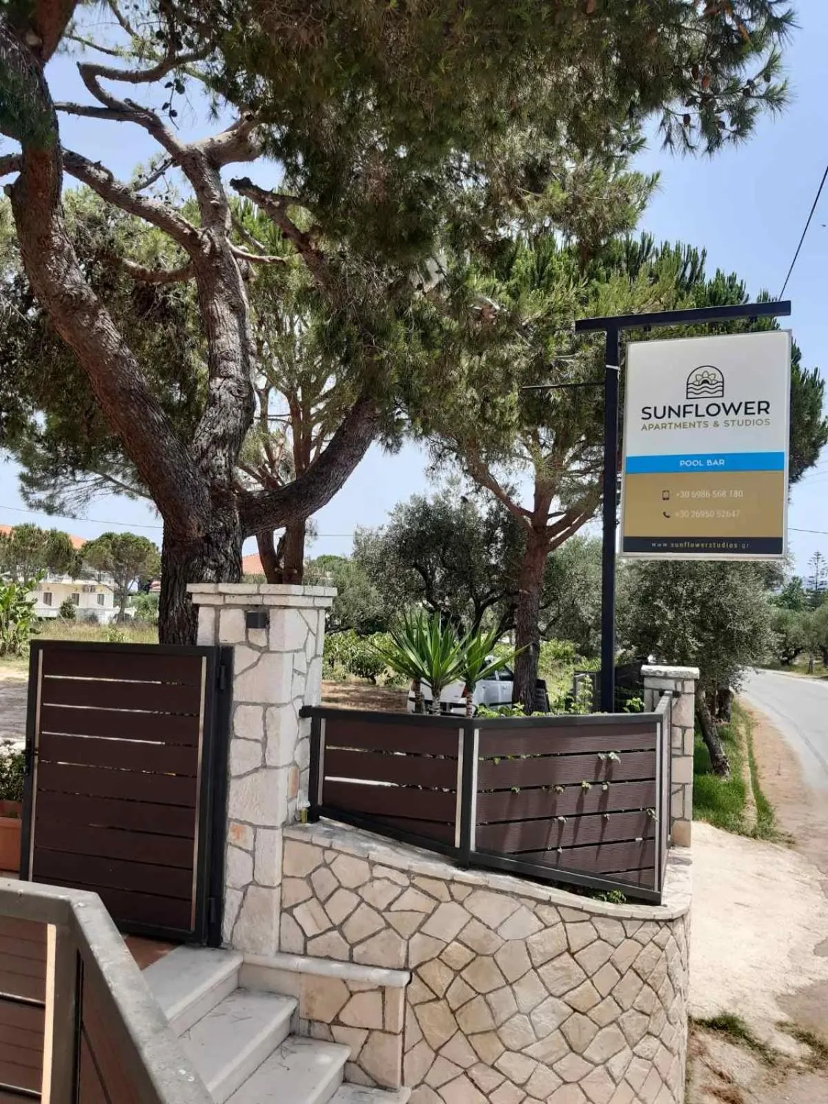 Property logo or sign in Sunflower Apartments & Studios