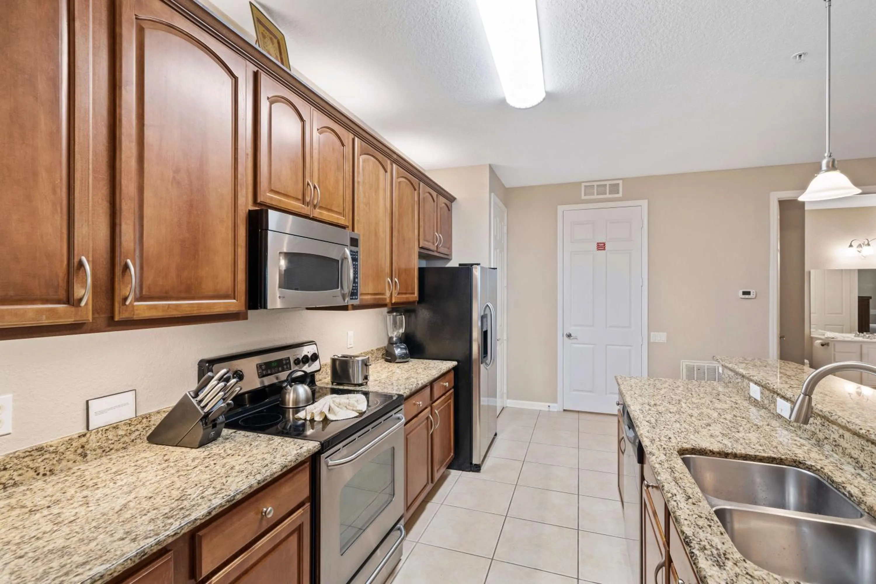 Kitchen or kitchenette in Orlando Resort Rentals at Universal Boulevard