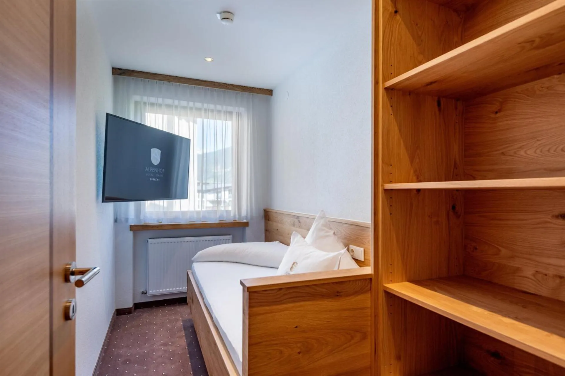 Bed in Alpenhof Hotel Garni Suprême