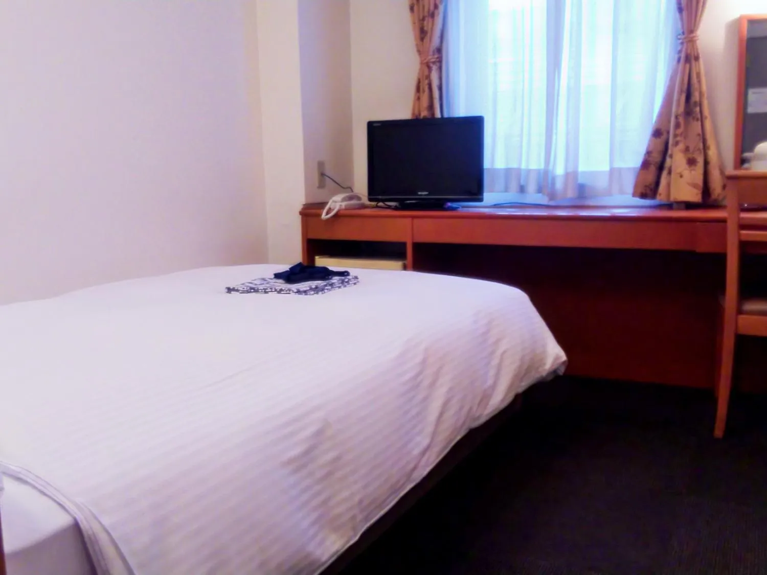 Bed in Natural Hot Spring Midosuji Hotel