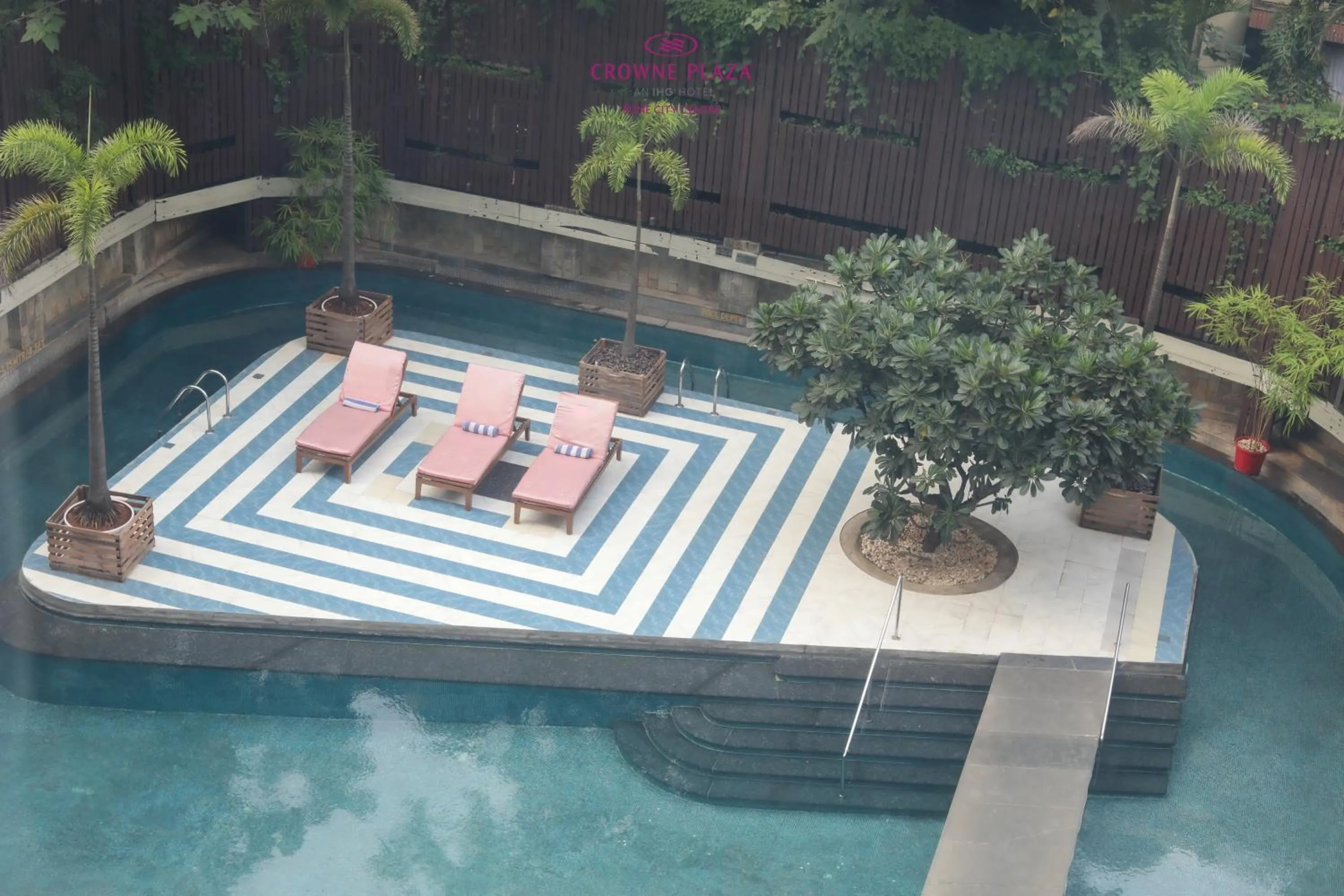 Swimming pool in Crowne Plaza Pune City Centre by IHG