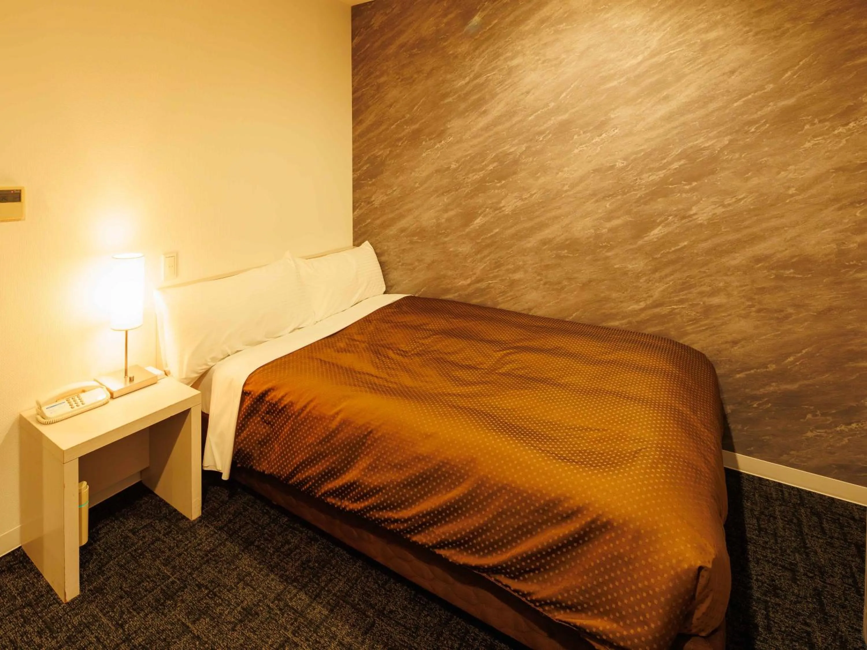 Bed in J Hotel Rinku