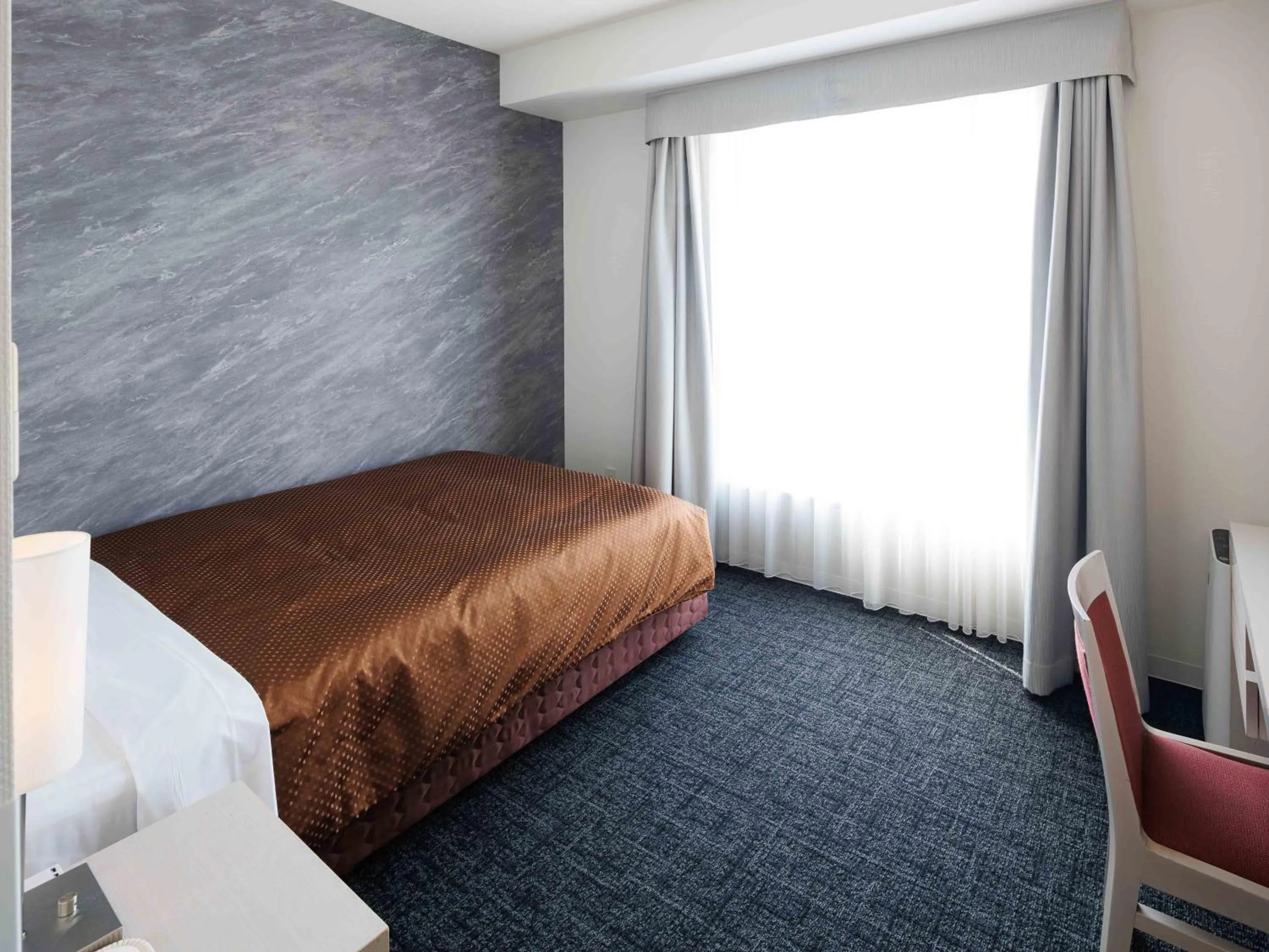 Bed in J Hotel Rinku