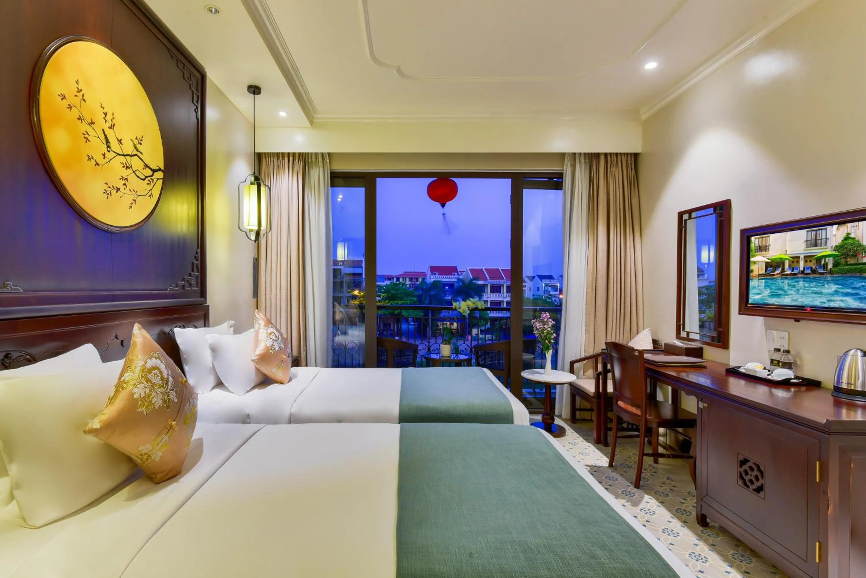 Communal lounge/ TV room, Bed in Laluna Hoi An Riverside Hotel & Spa