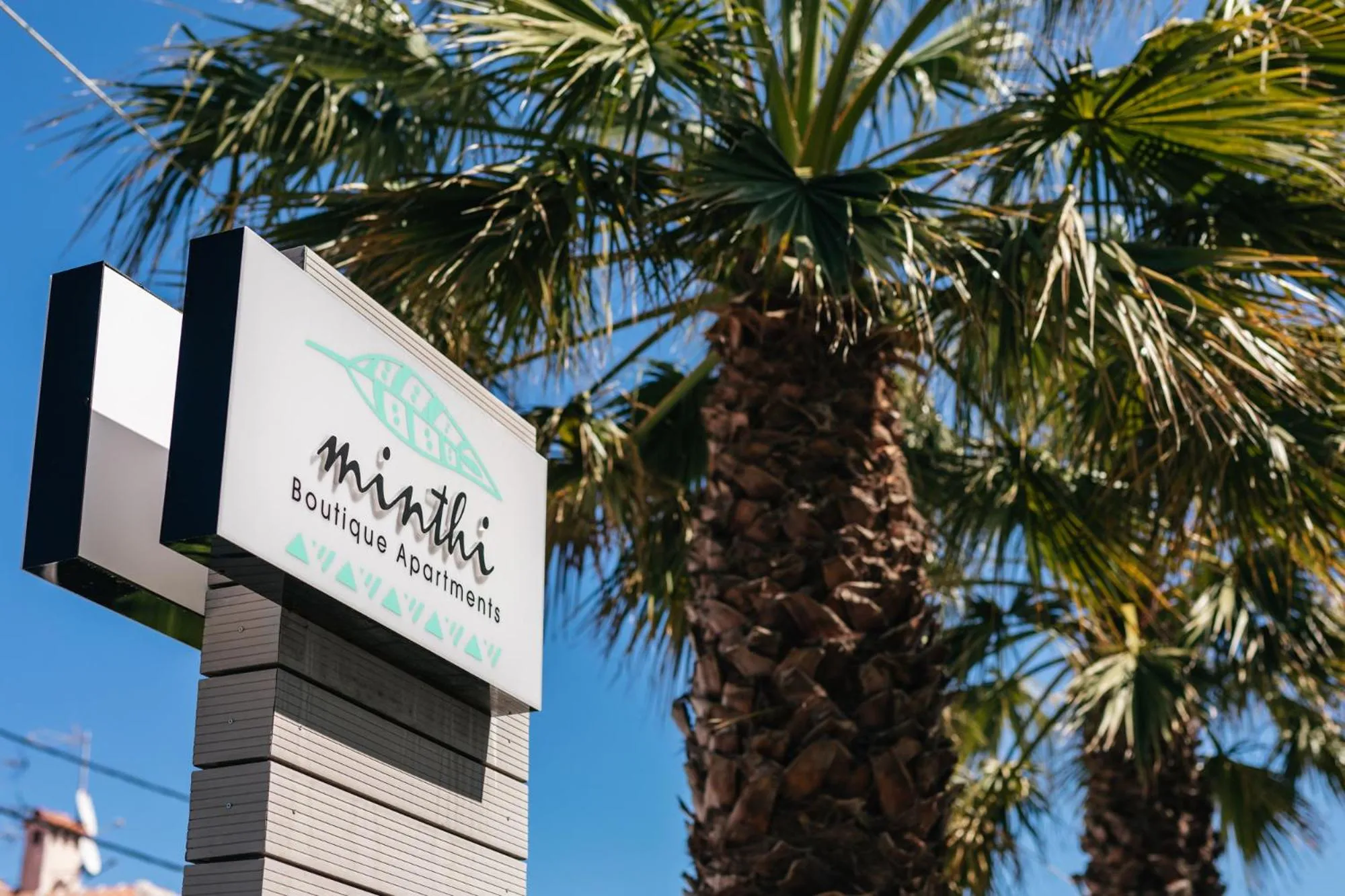 Property logo or sign in Minthi Boutique Apartments