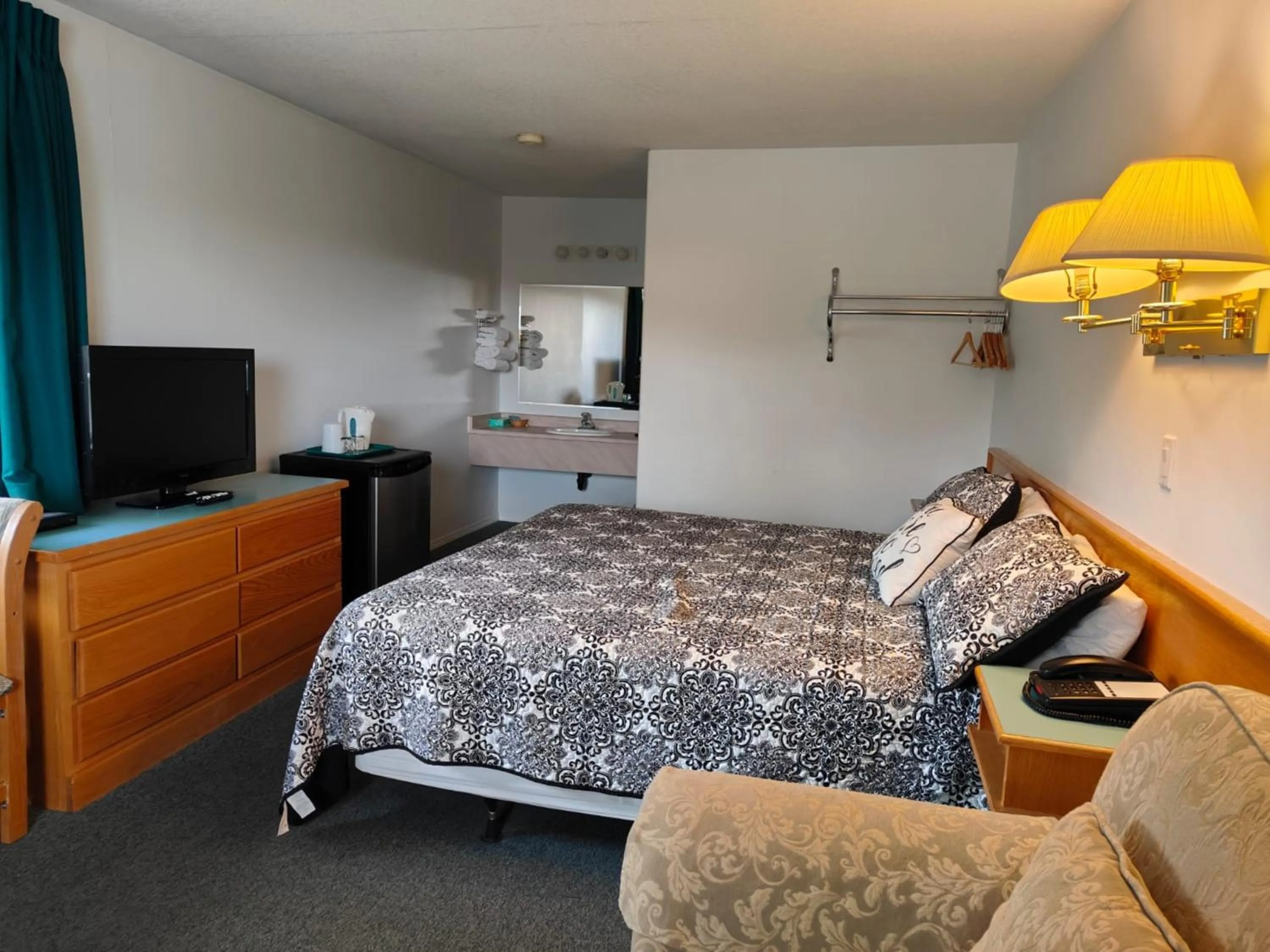 Communal lounge/ TV room, Bed in Ponderosa Motor Inn