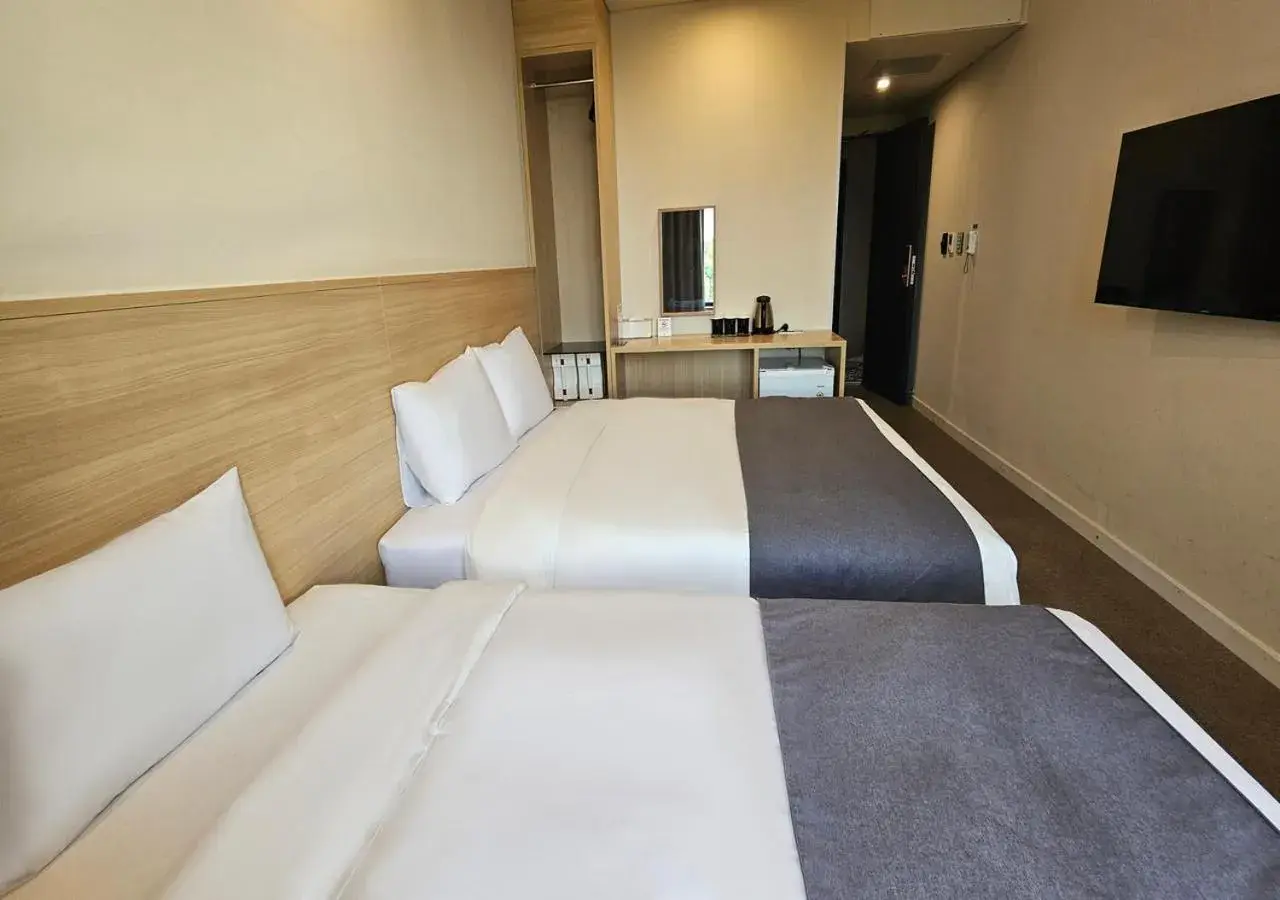 Bed in JK Blossom Hotel Bed in JK Blossom Hotel